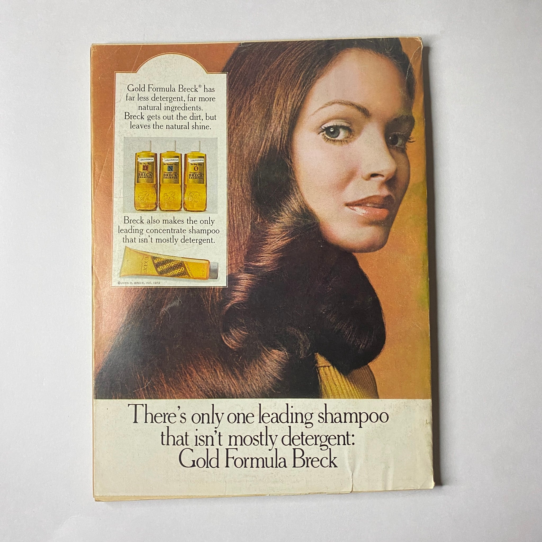 Advertisement from Glamour Magazine May 1972 for Gold Formula Breck shampoo emphasizing its effectiveness and natural ingredients; features a model with long, lustrous hair.