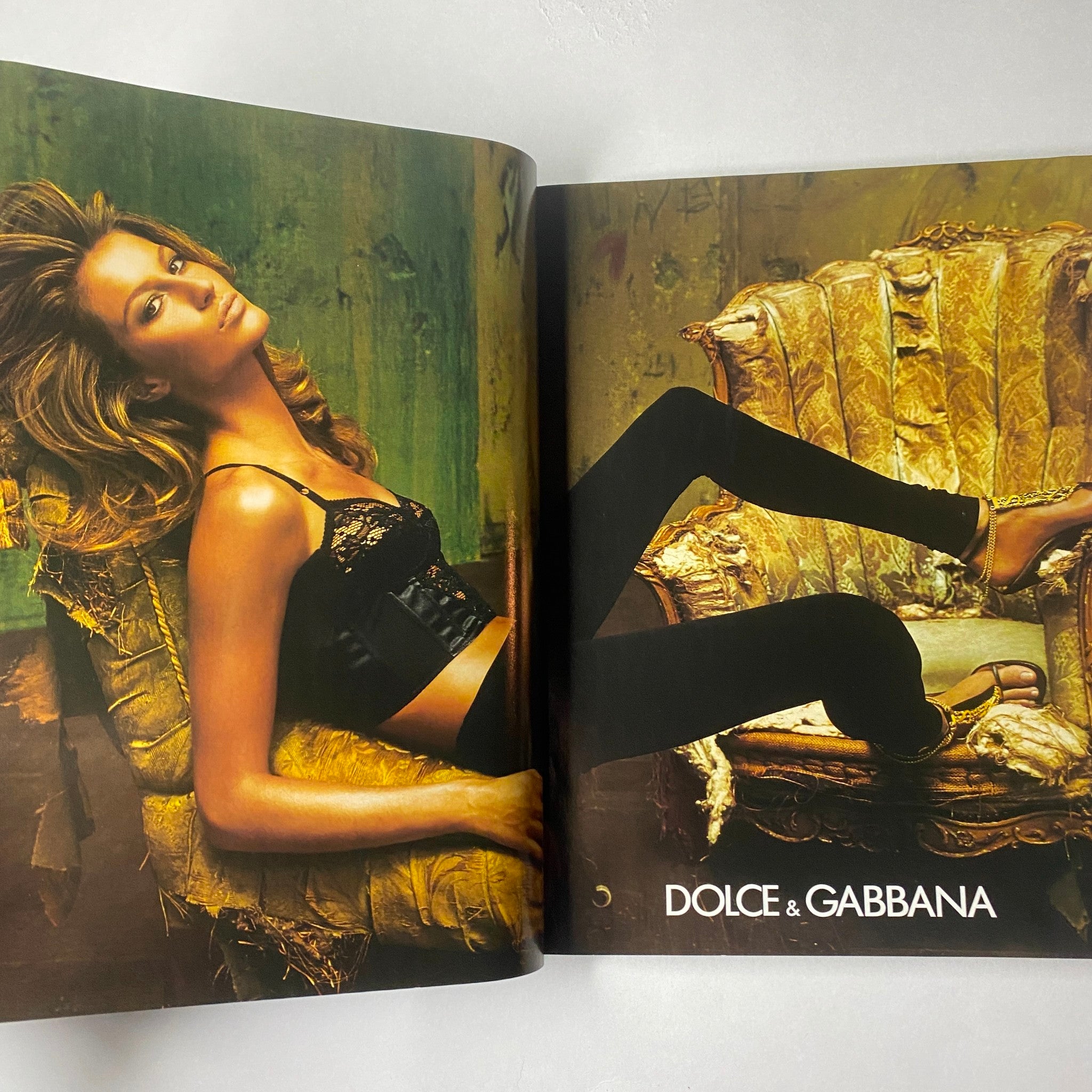 Marie Claire Italia Magazine February 2003 featuring a stylish fashion spread with a model showcasing Dolce & Gabbana designs in a bold artistic flair against a textured backdrop.