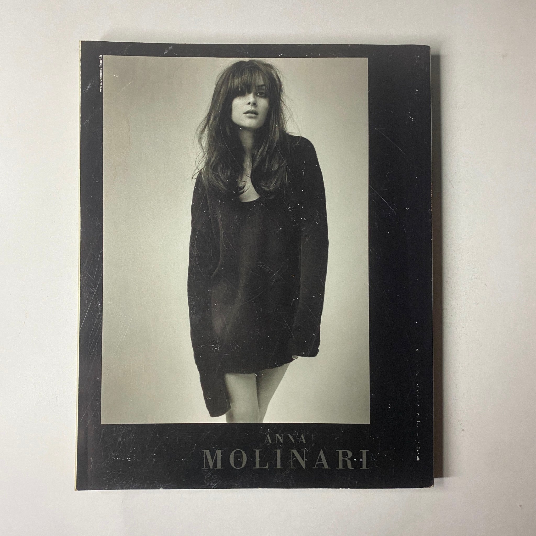 Marie Claire Italia Magazine February 2003 cover image featuring a fashion model named Anna Molinari in a striking black outfit, exuding elegance and contemporary style.