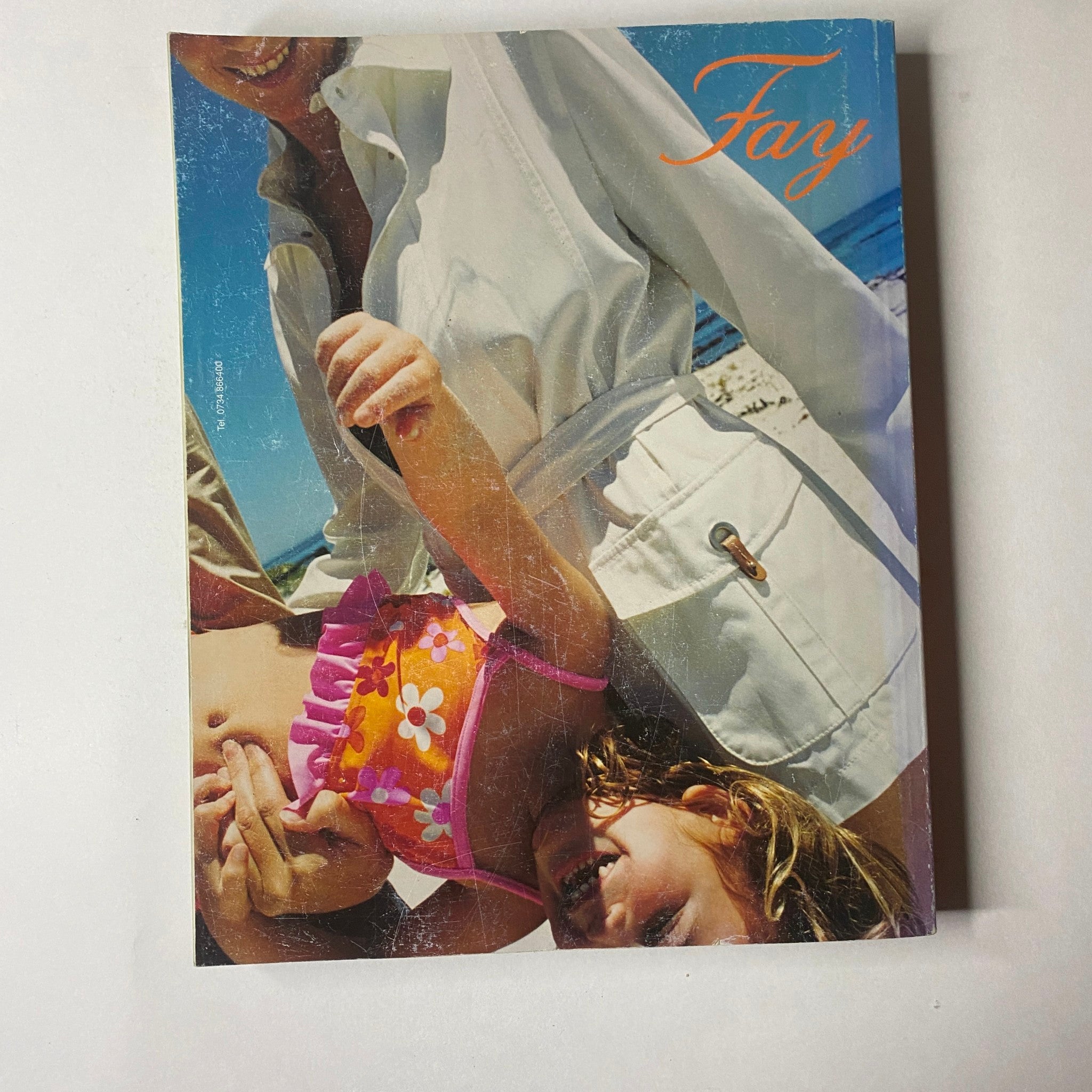 Back cover of Marie Claire Italia Magazine April 2003 featuring an advertisement for Fay, showcasing a vibrant image of a woman with a child.
