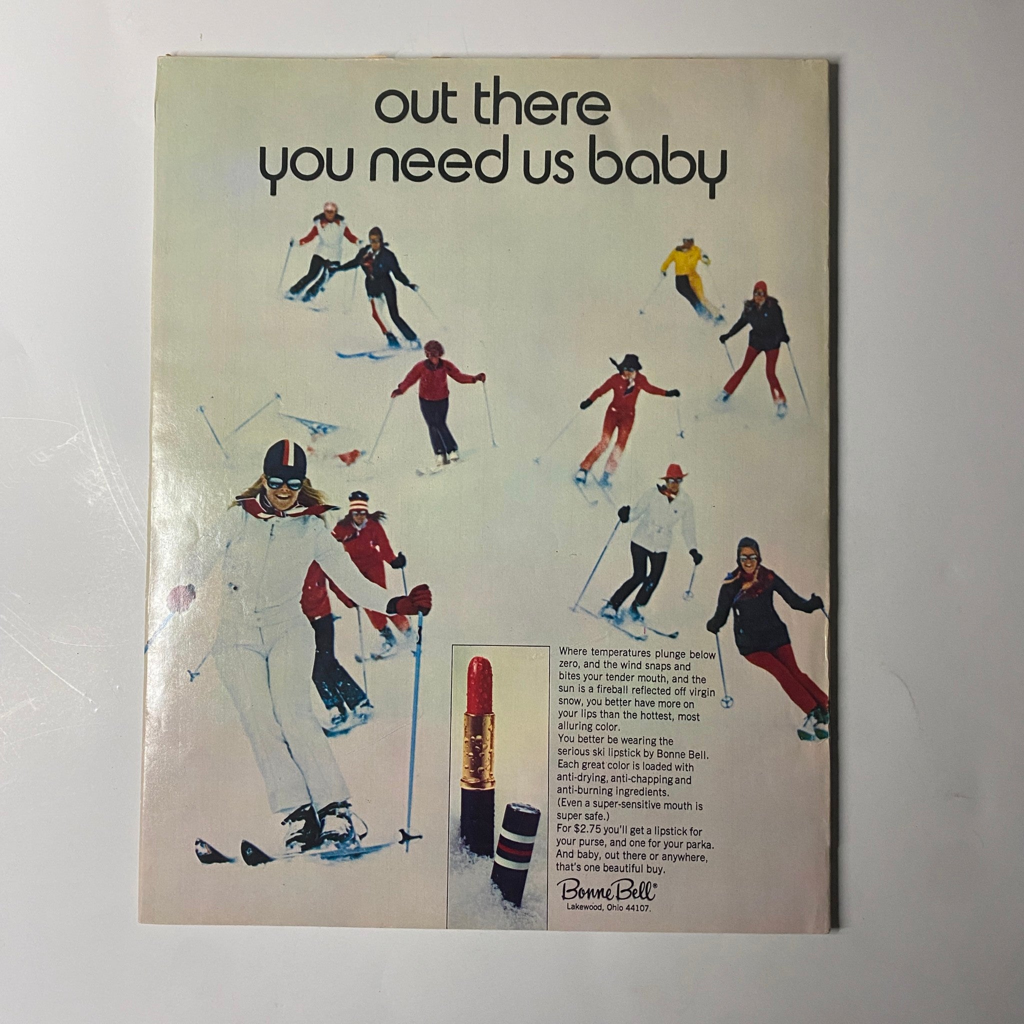Ad from Seventeen Magazine January 1971 promoting ski fashion, featuring models on skis with a lipstick advertisement, illustrating 1970s style trends.