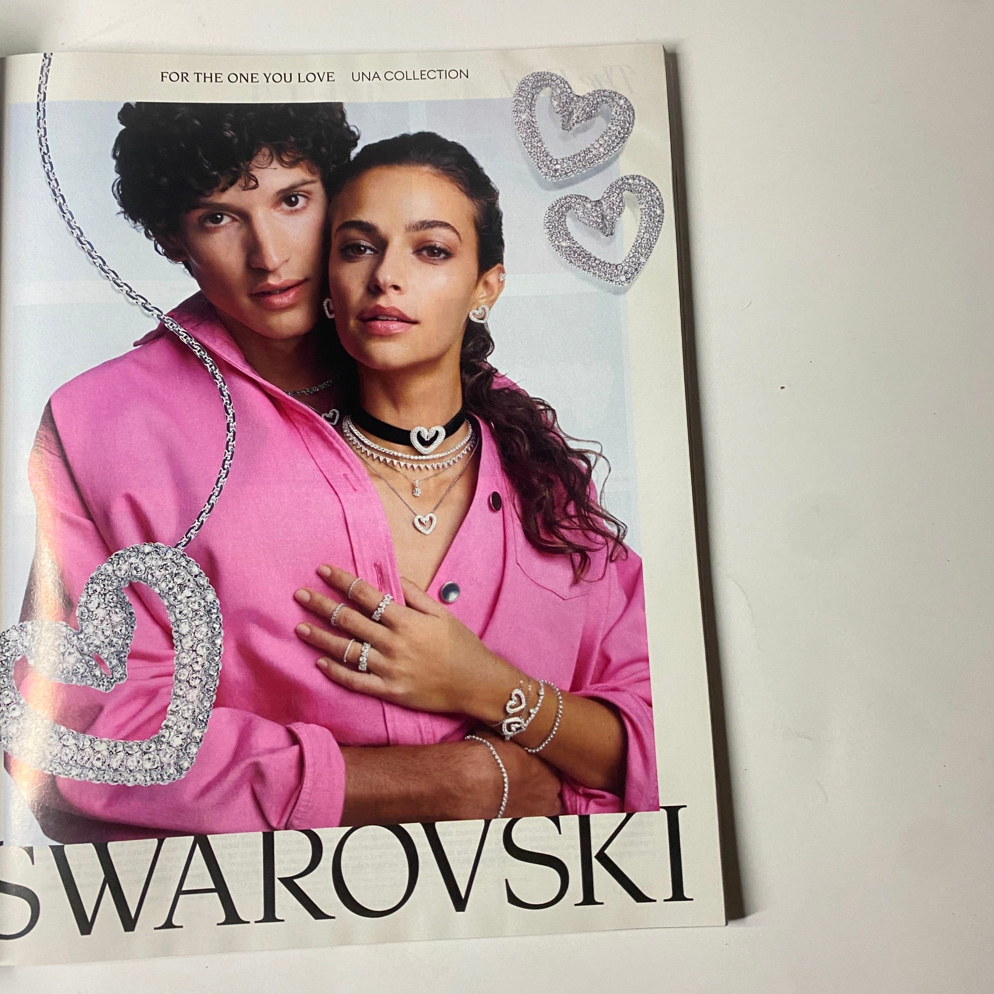 Elle Magazine March 2022 Zoë Kravitz Cover showcasing Swarovski jewelry with a couple modeling heart-themed pieces, emphasizing elegance and modern romance.