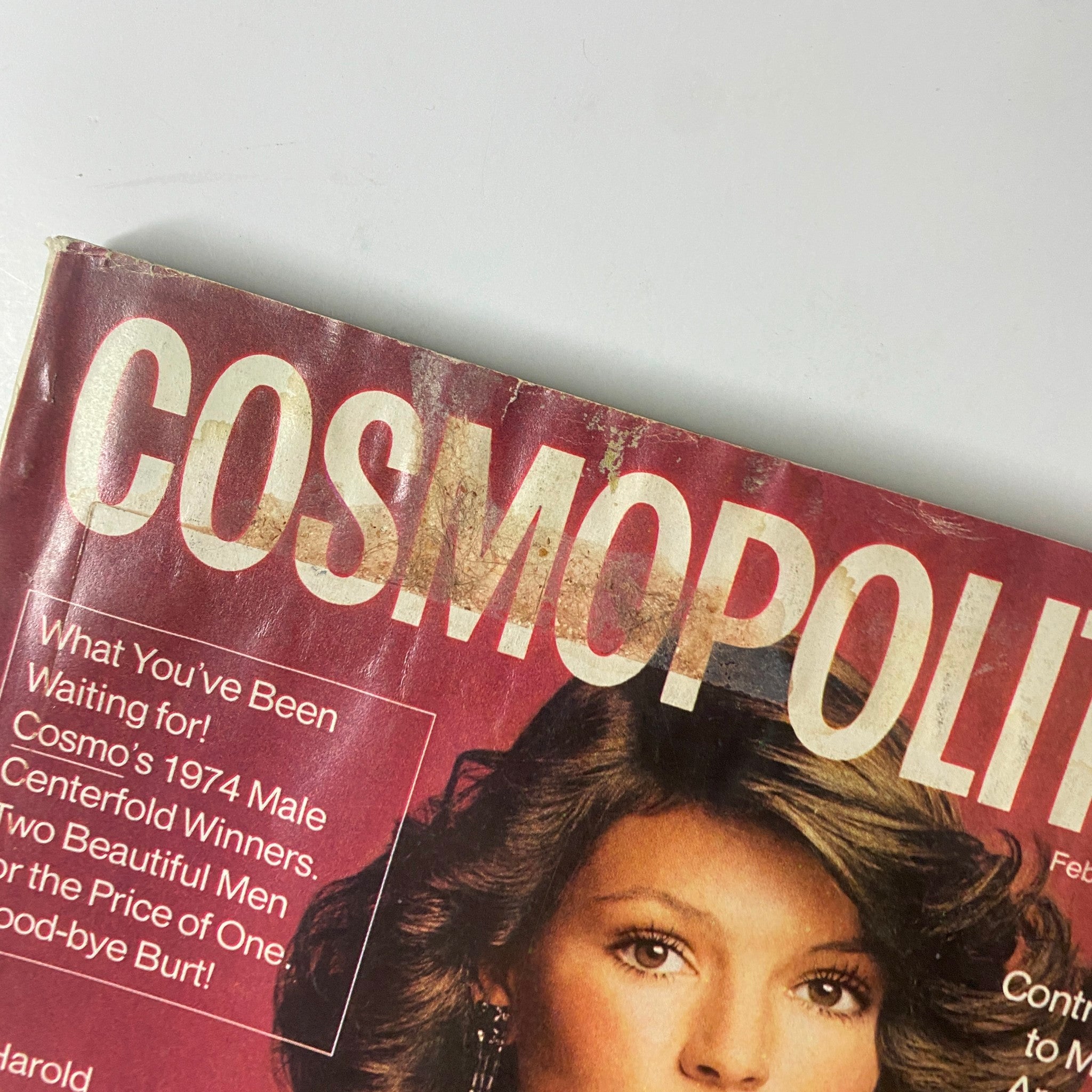 Close-up of the Cosmopolitan Magazine February 1974 cover, highlighting the title and part of the cover story featuring Barbara Minty, reflecting 1970s women's media.