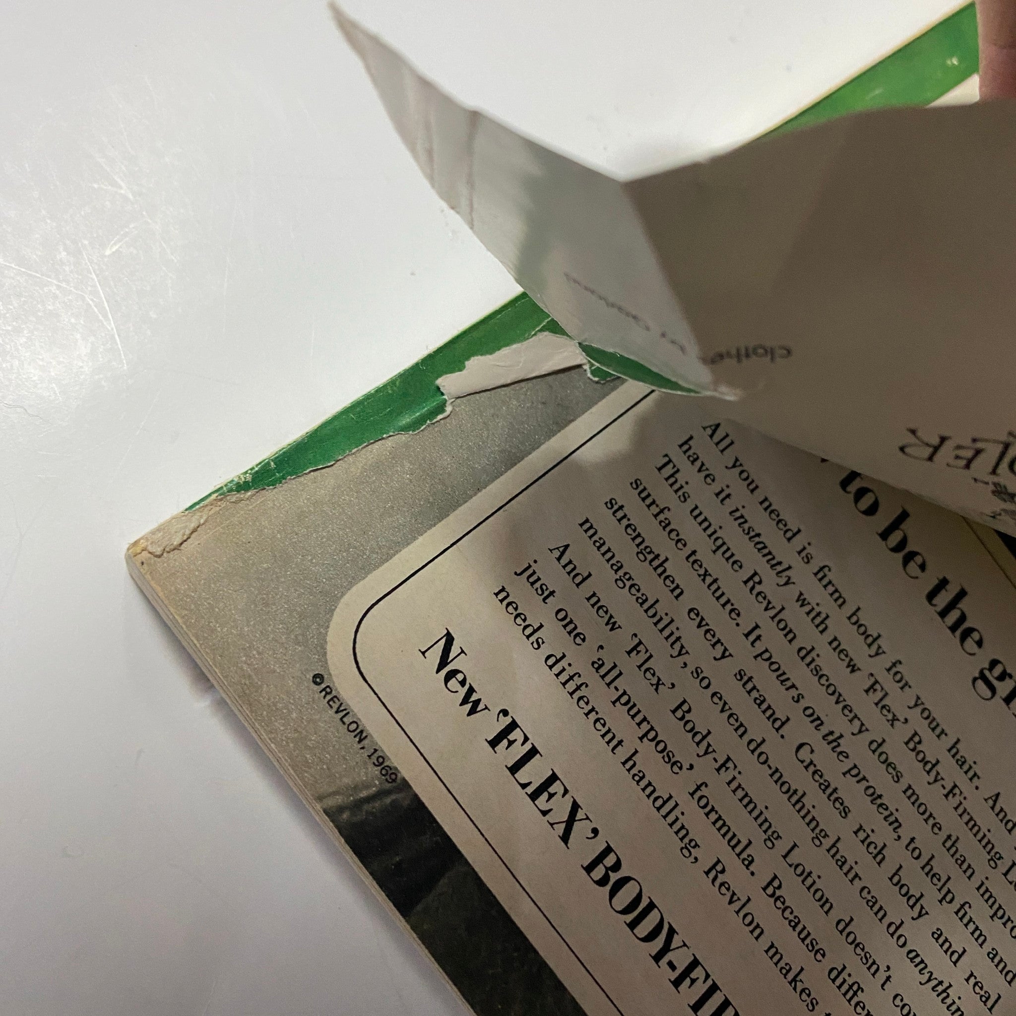 A close-up of the damaged corner of the Seventeen Magazine August 1969 Fashion Issue, showing wear and tear, highlighting its acceptable condition.