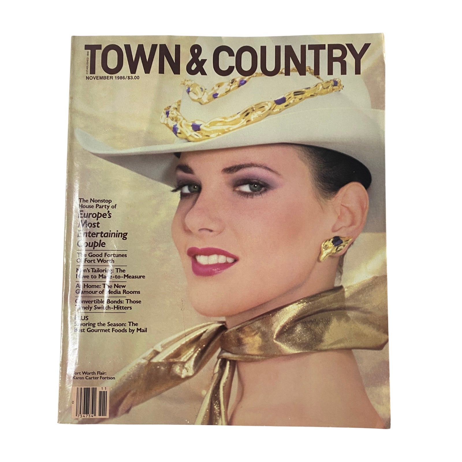 Town & Country Magazine November 1986 cover featuring model Karen Carter Fortson, showcasing elegance with a white hat, bold earrings, and glamorous makeup.