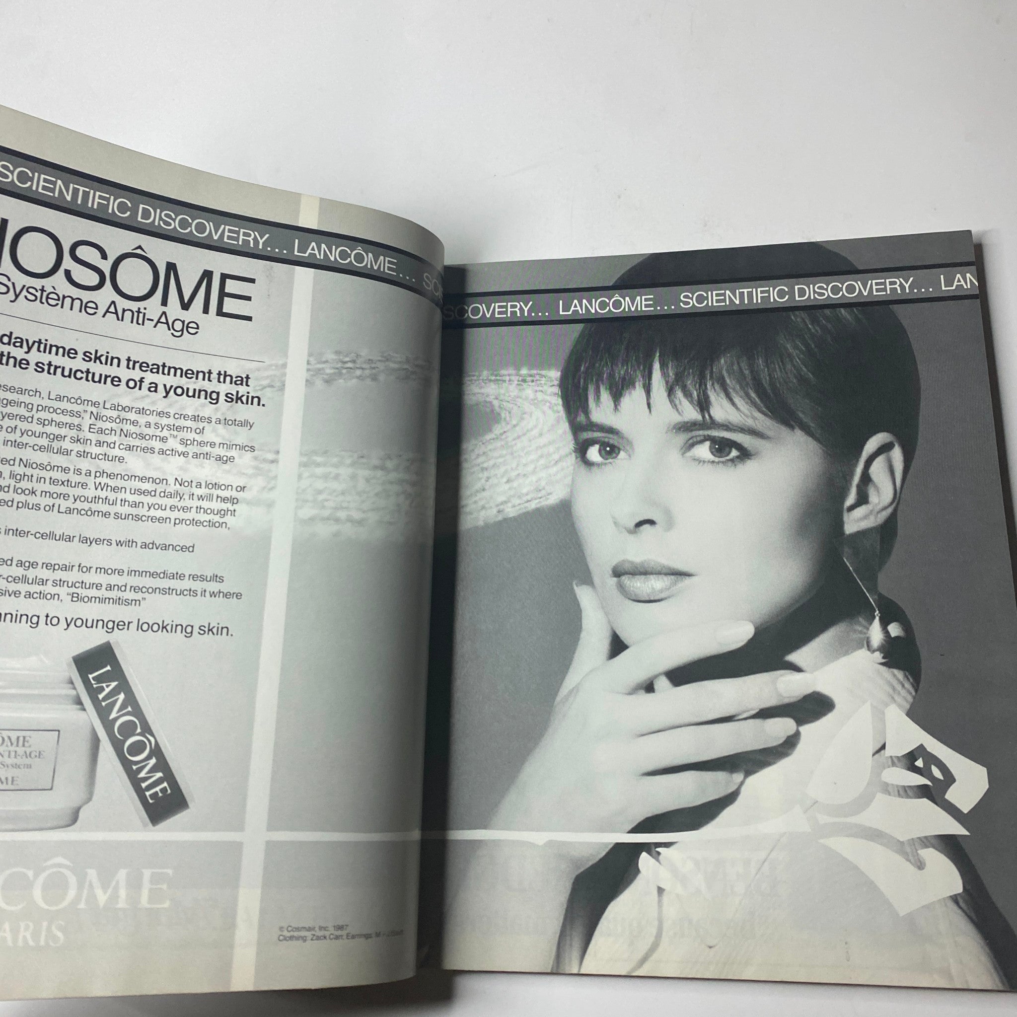 Inside spread from Town & Country Magazine March 1987 featuring a Lancôme skincare advertisement showcasing a model with sleek hair and luxurious makeup, emphasizing scientific discovery in skincare.