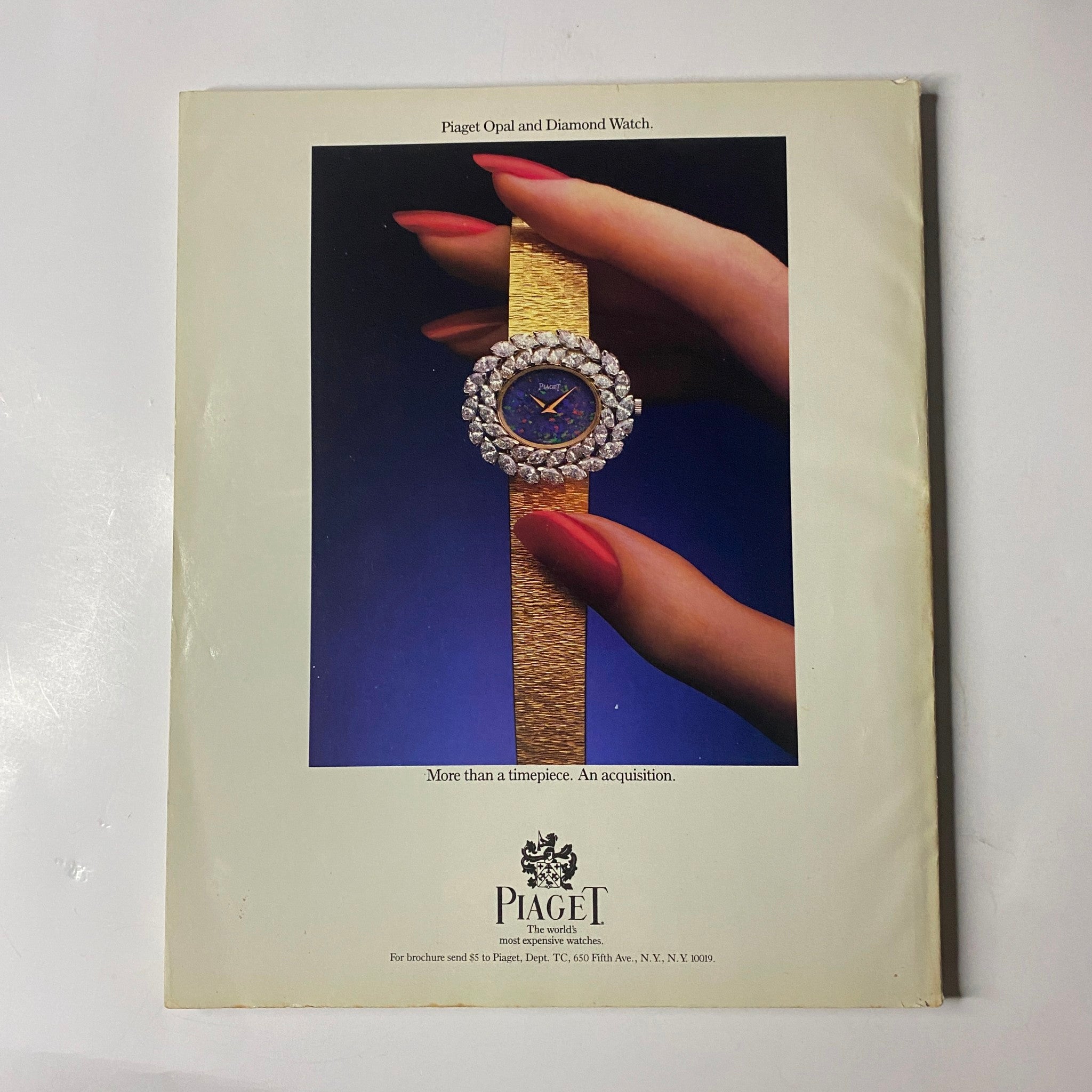 Back cover of Town & Country Magazine March 1987 featuring an advertisement for a Piaget opal and diamond watch, highlighting elegance with a model's hand adorned in long red nails holding the luxurious timepiece.