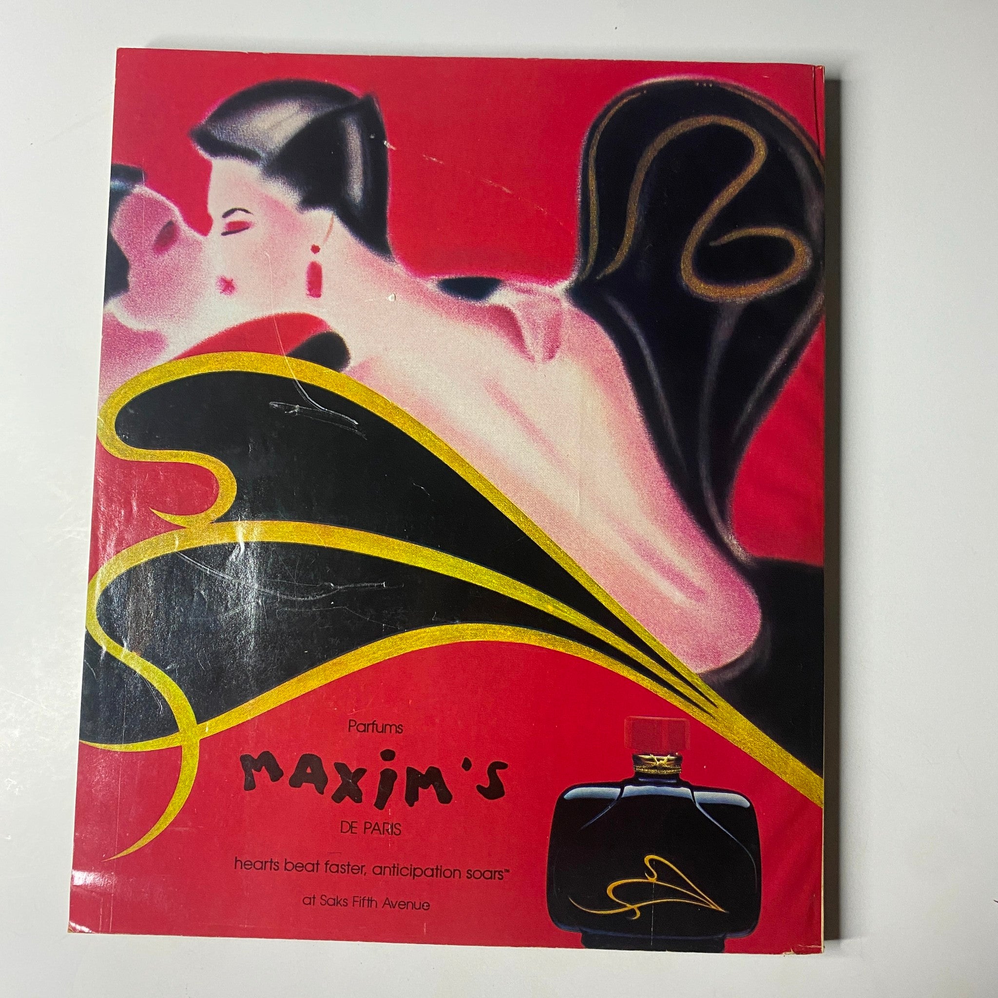 Vintage advertisement for Maxim's de Paris from Town & Country Magazine May 1985, featuring a striking artwork for perfume.