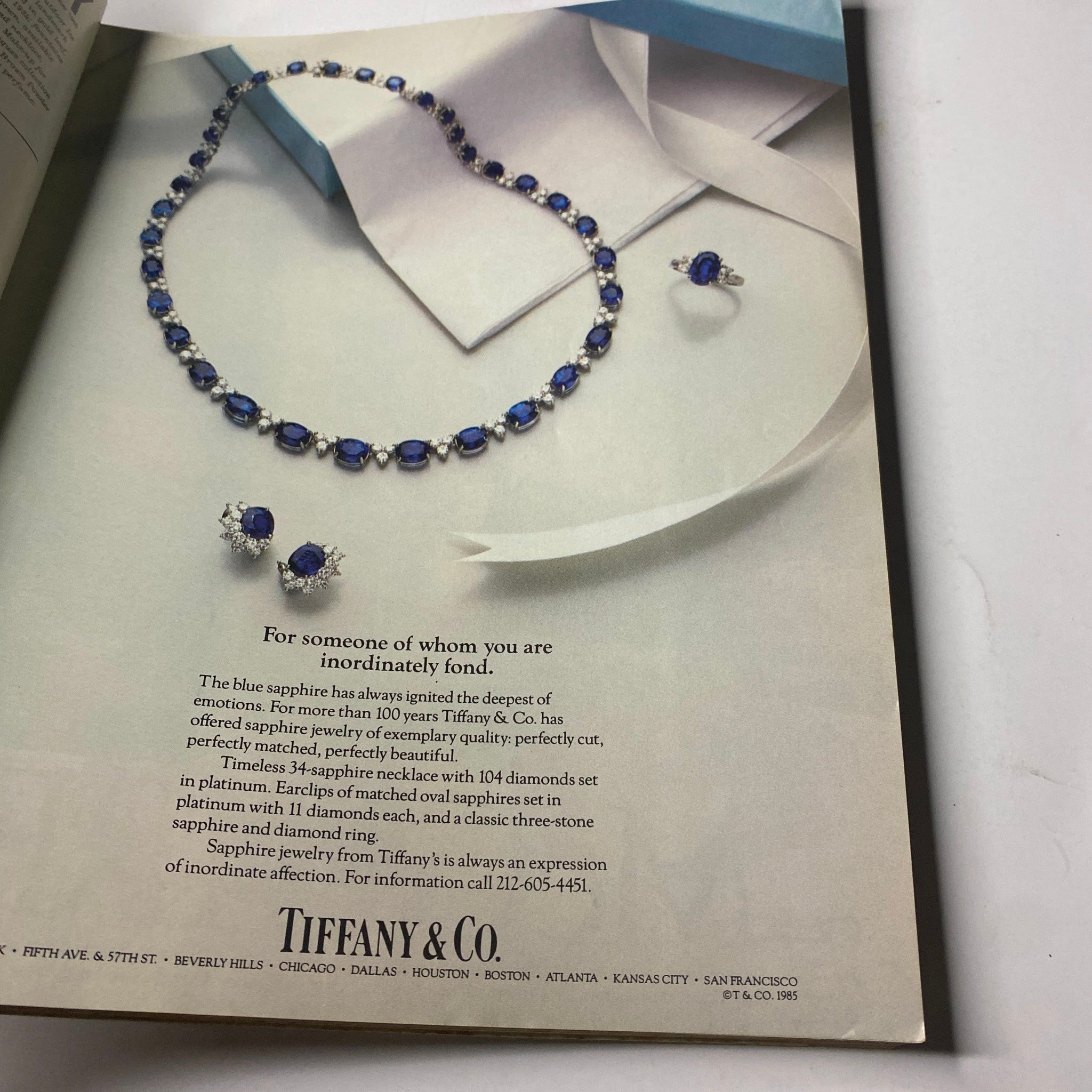 Tiffany & Co. advertisement featuring a stunning sapphire necklace and earrings, highlighting the elegance of blue sapphire jewelry, from the Town & Country Magazine September 1985 issue with Nina Griscom cover.