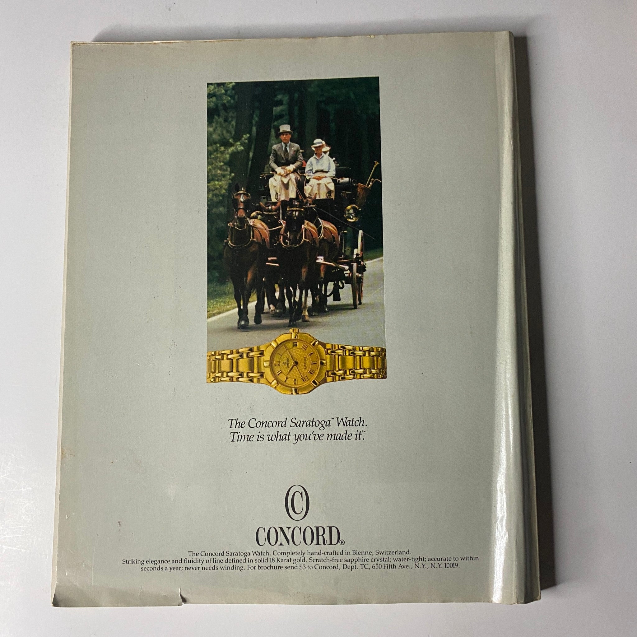 An advertisement for the Concord Saratoga watch, depicting a scenic horse-drawn carriage. Town & Country Magazine September 1986 Fiona Biggs Cover No Label.