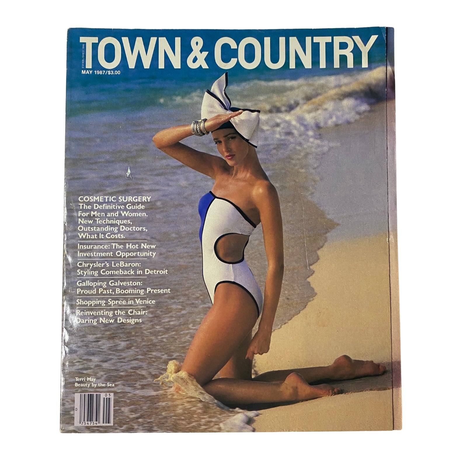 Cover of Town & Country Magazine May 1987 featuring Texas beauty Terri May in a stylish swimsuit on the beach, symbolizing elegance and summer fashion.