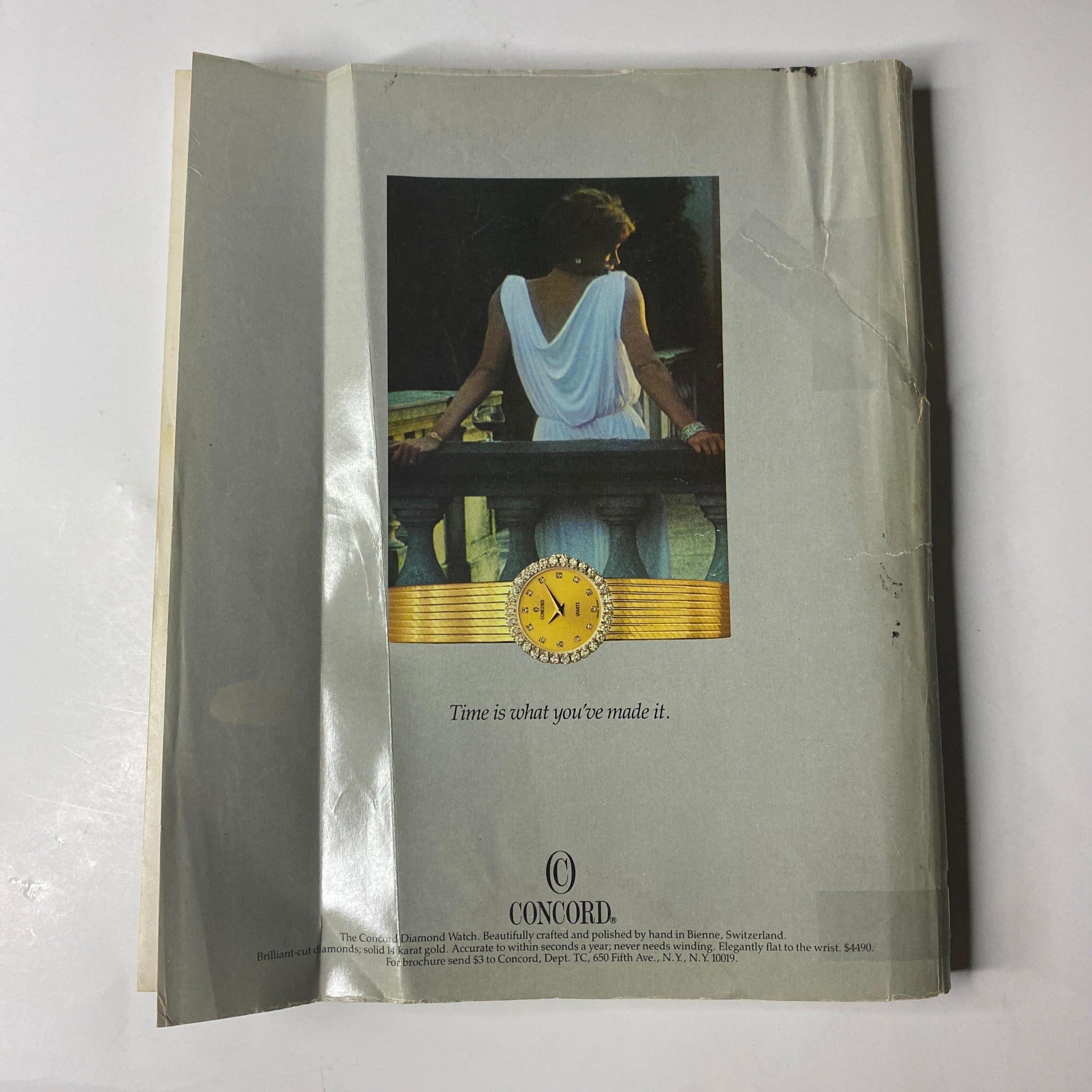 Town & Country Magazine November 1985 displaying a Concord watch advertisement featuring a woman in a white dress gazing into the distance, illustrating the theme of time. No Label.