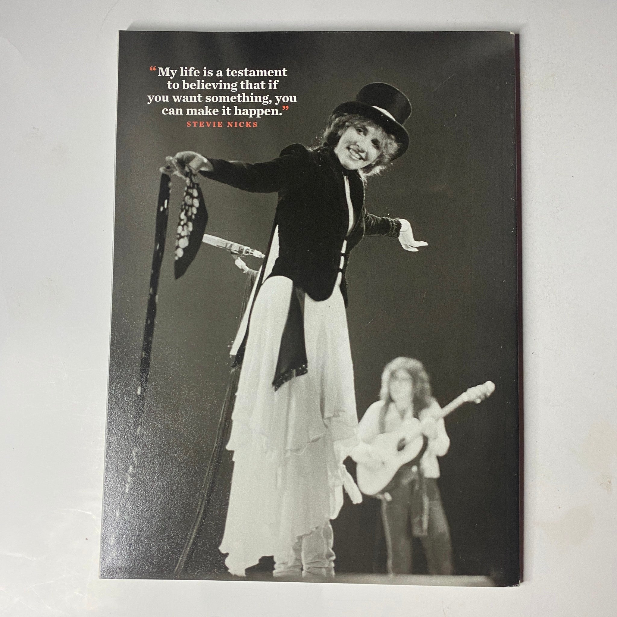 Stevie Nicks performing on stage, wearing a signature top hat and coat, with the quote 'My life is a testament to believing that if you want something, you can make it happen.' Featured in the Stevie Nicks Magazine January 02 2023 Photo Book.