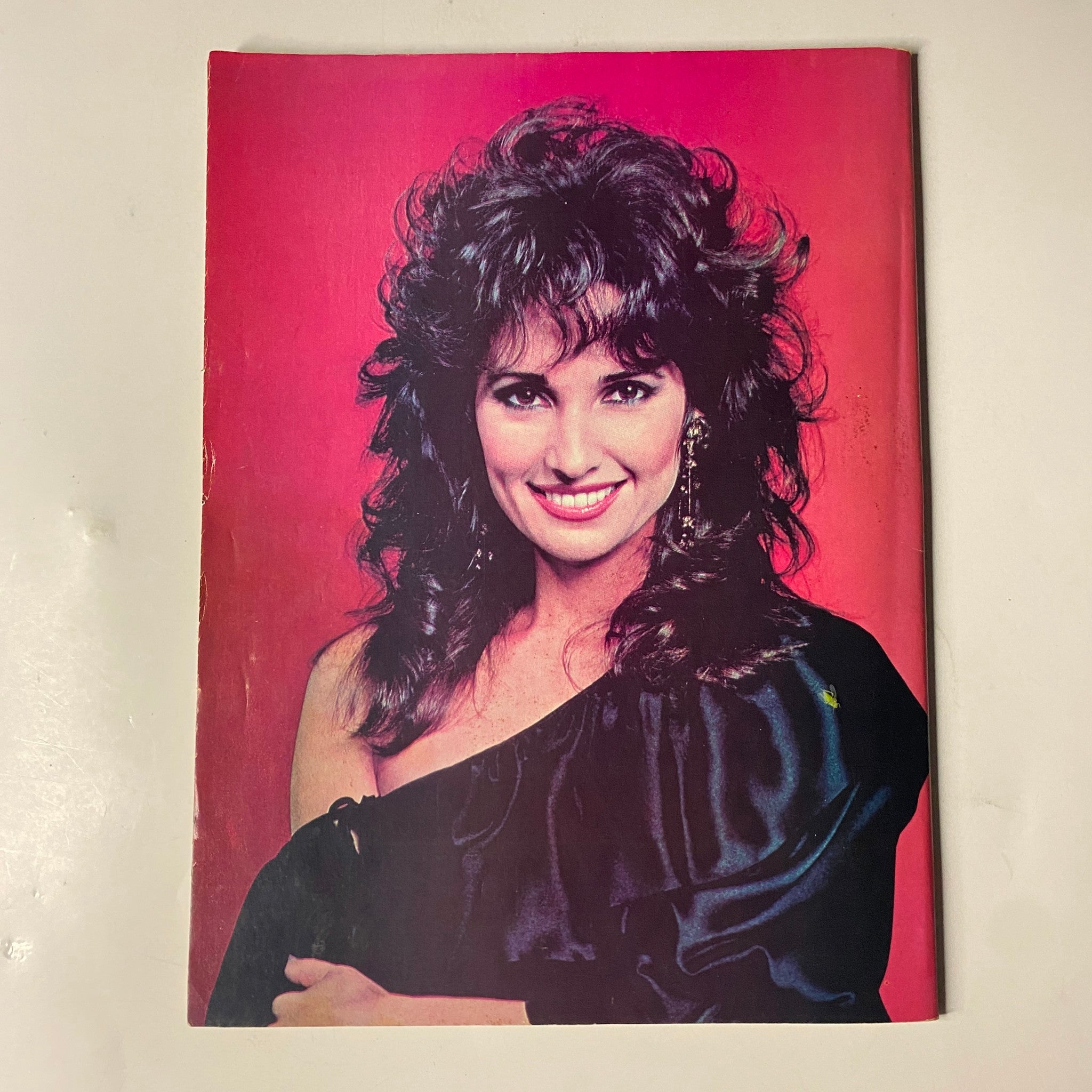 Cover image of the 1984 Afternoon TV Yearbook featuring Steve Bond and Leslie Charleson. The vibrant design includes a striking portrait of Leslie Charleson against a red background, highlighting her glamorous hairstyle and attire.