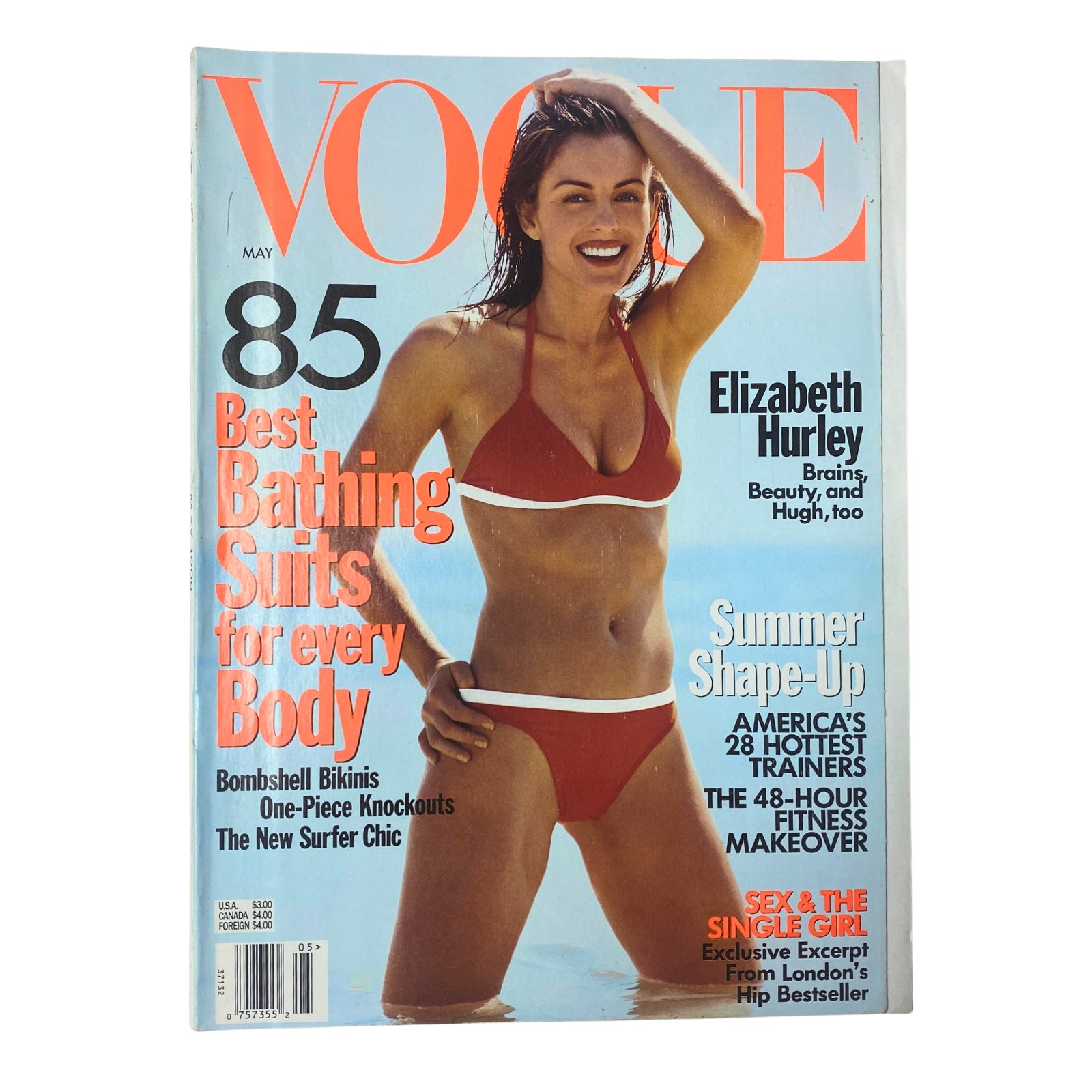 Vogue Magazine May 1998 featuring Elizabeth Hurley on the cover, showcasing her in a red bikini, highlighting style and fashion trends of the late 1990s. Very Good Condition, collectible item for Vogue enthusiasts.
