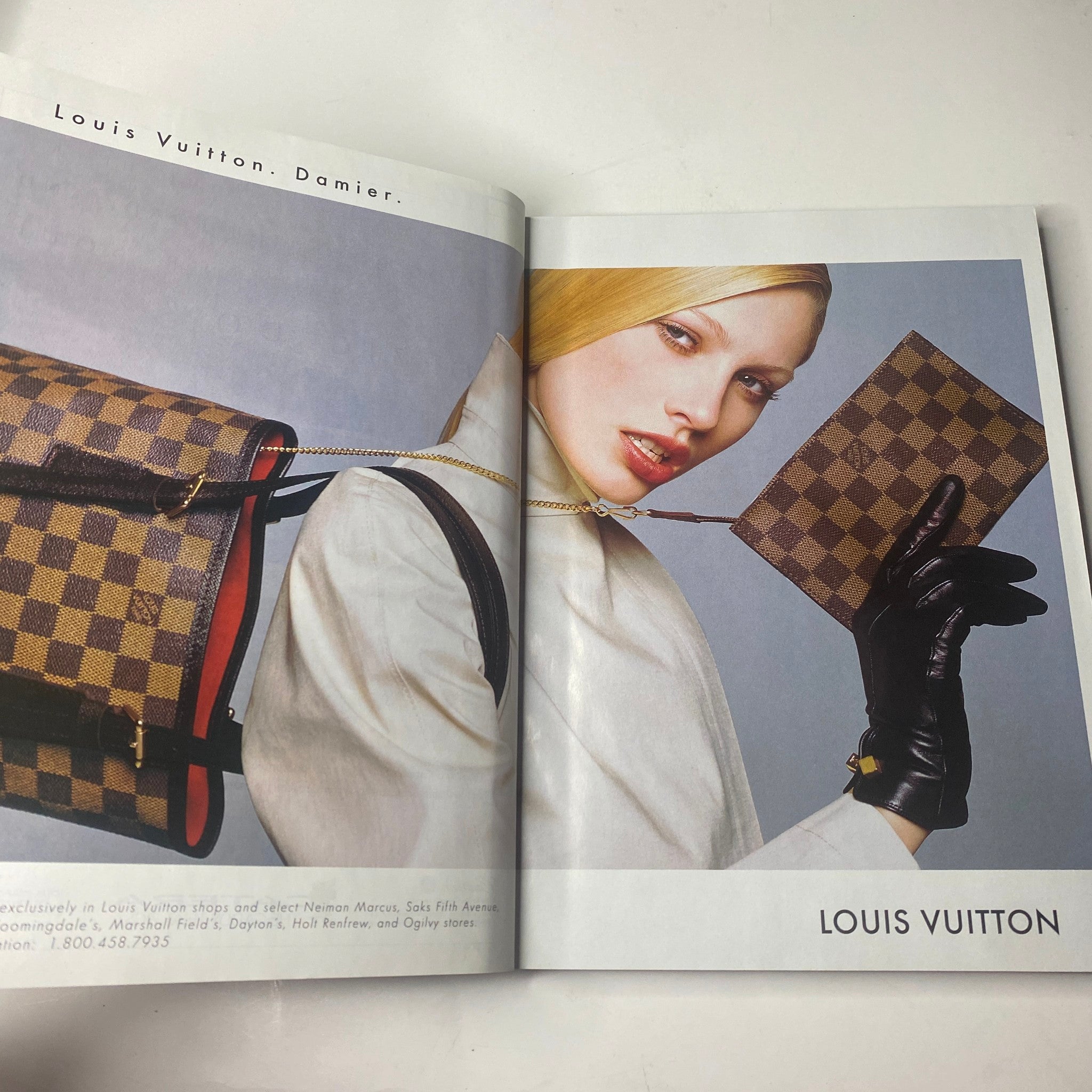 Advertisement page in Vogue Magazine May 1998 for Louis Vuitton, featuring a stylish model showcasing a signature Damier pattern handbag and fashionable attire.