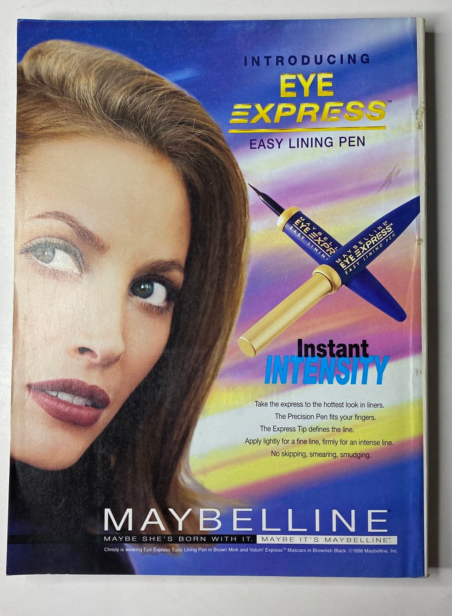 Maybelline advertisement introducing Eye Express easy lining pen featuring a model with bold eye makeup. Vogue Magazine April 1998 Amber Valletta Cover No Label VG.