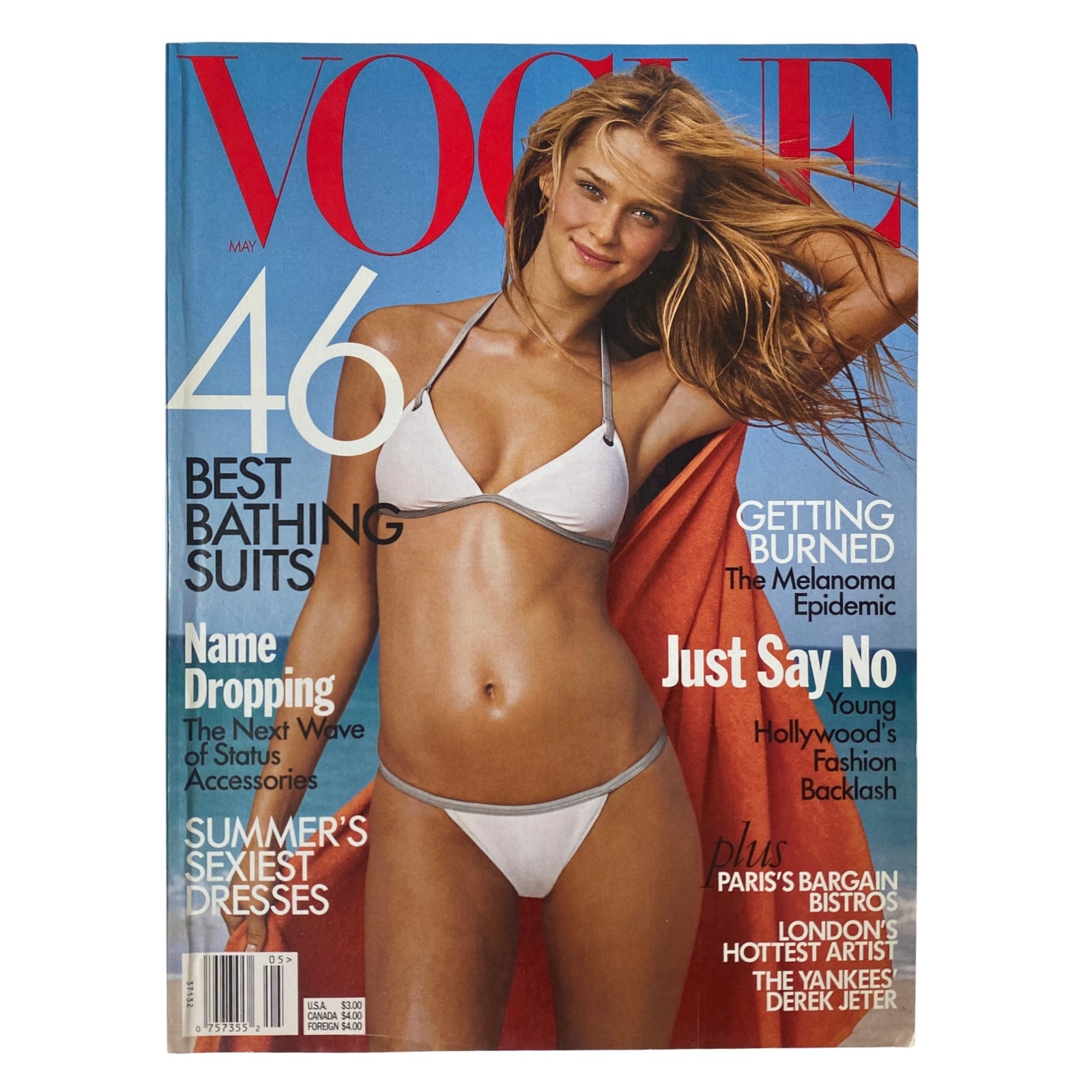 Vogue Magazine May 1999 featuring Carmen Kass on the cover in a white bikini, emphasizing summer fashion trends, including best bathing suits and seasonal accessories.