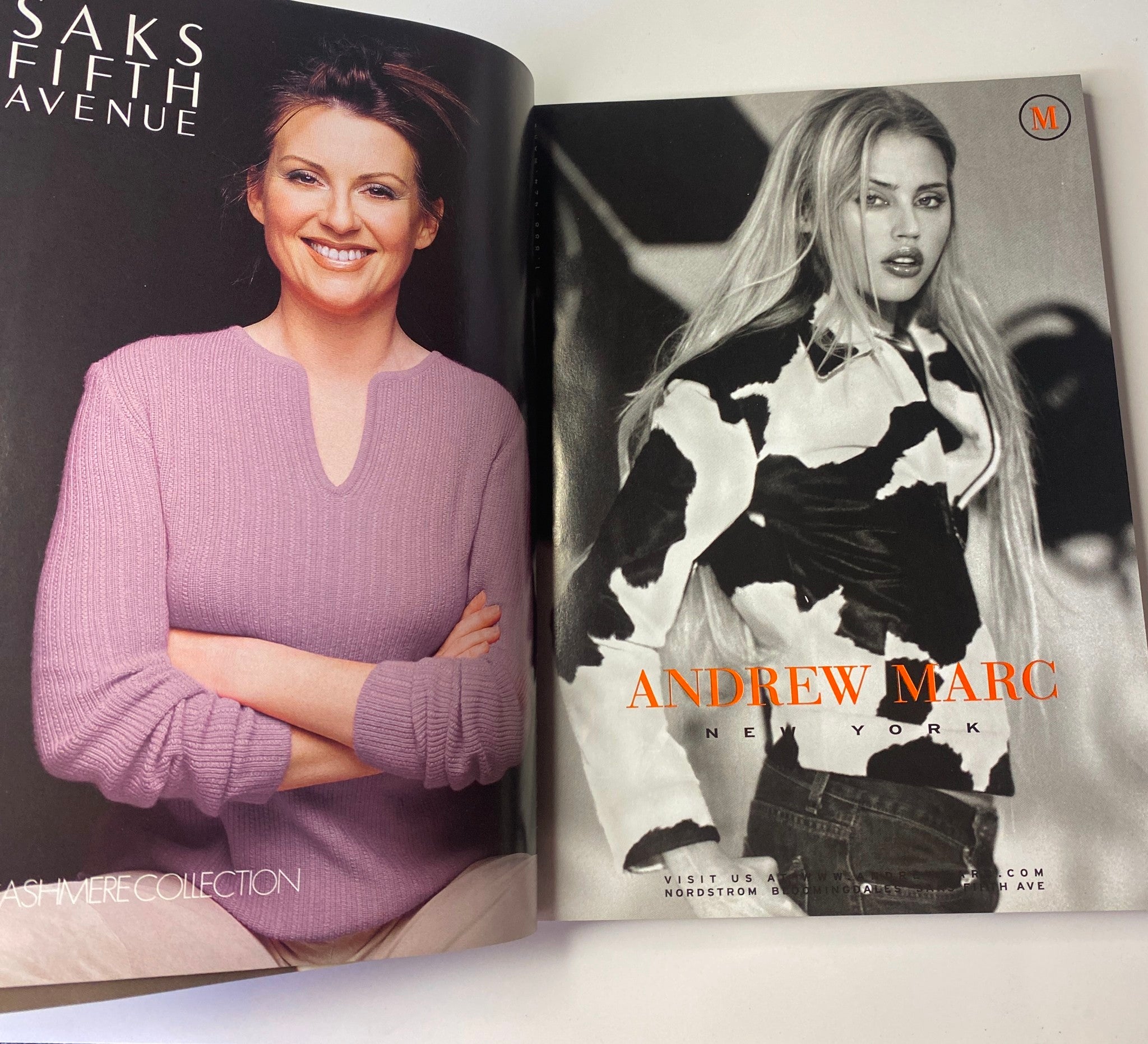 Vogue Magazine October 1999 Winona Ryder Cover featuring an advertisement for Andrew Marc, displaying a model in a stylish black and white ensemble, highlighting modern fashion trends.