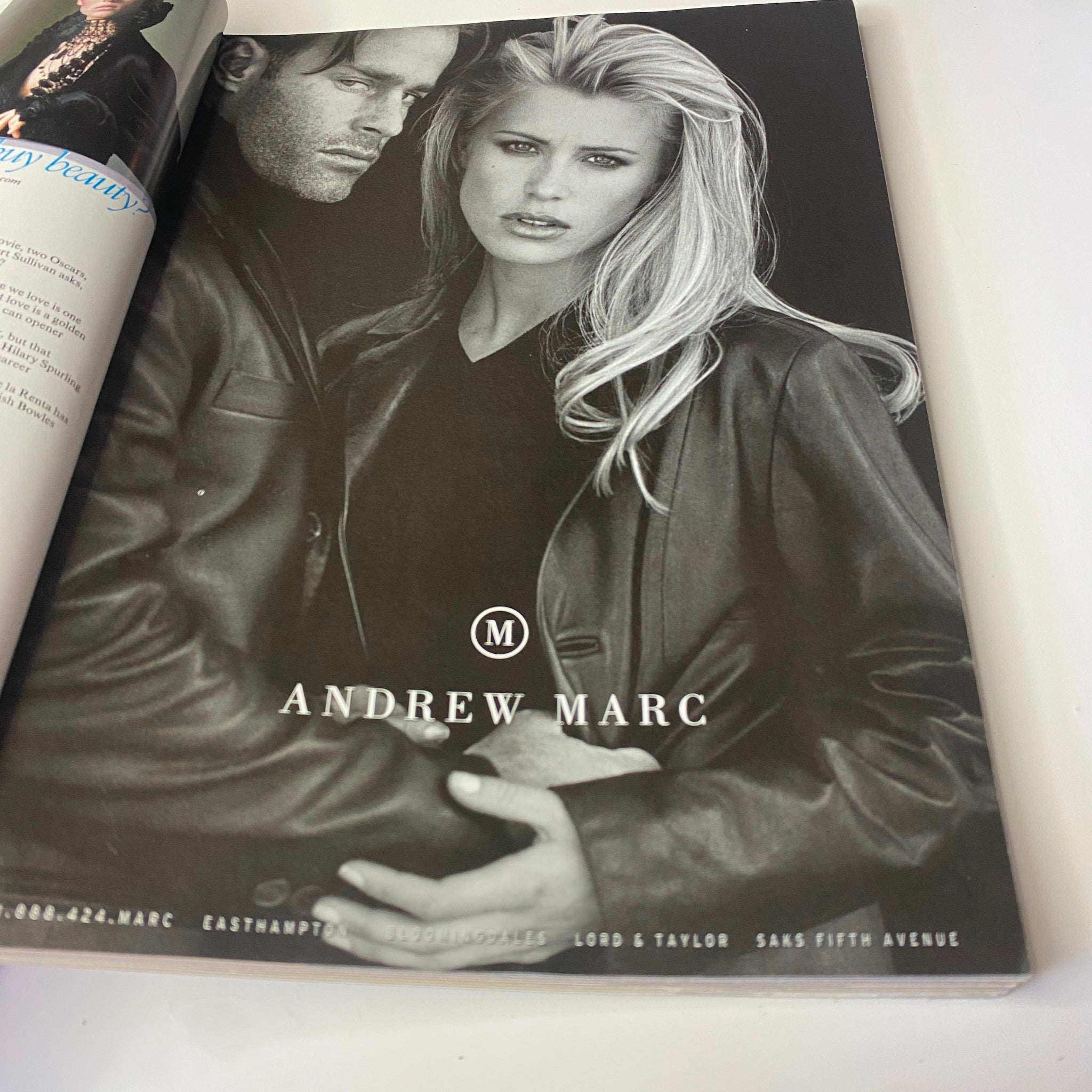 Vogue Magazine December 1998 advertisement for Andrew Marc showcasing fashion model with a striking look, emphasizing style trends of the late 1990s.