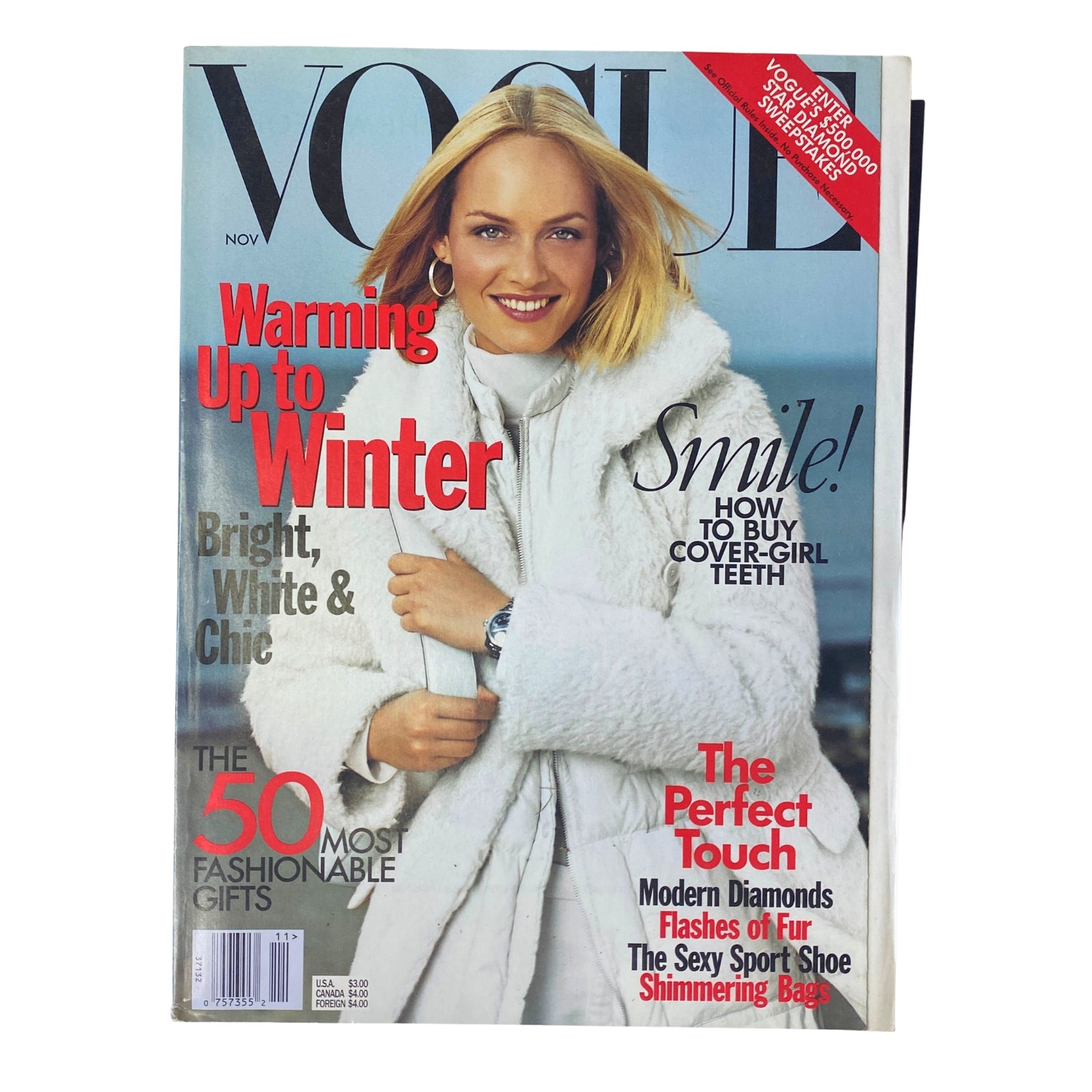 Vogue Magazine November 1998 Amber Valletta Cover showcasing fashion theme 'Warming Up to Winter' with a bright white chic style.