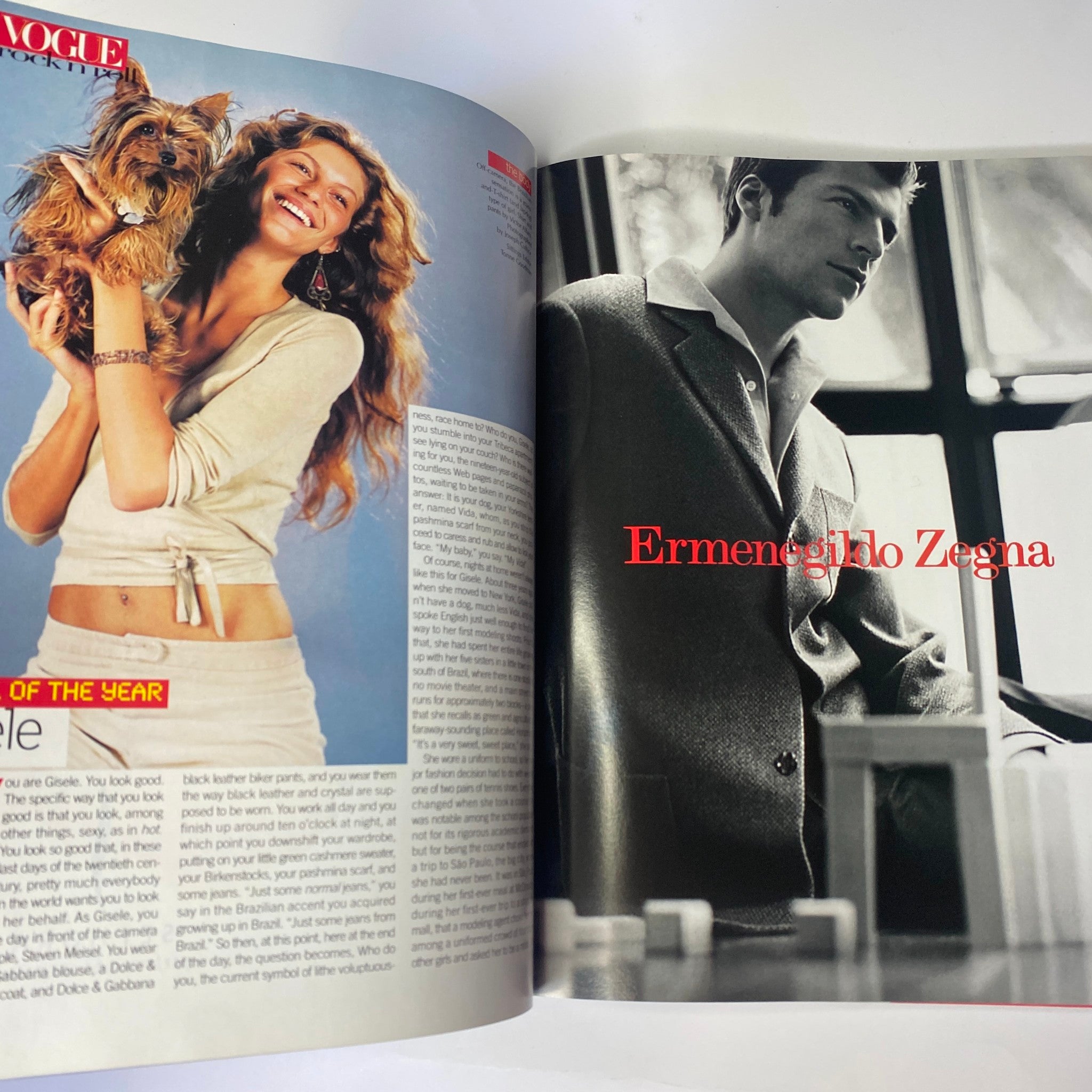 Vogue Magazine December 1999 Gisele Bündchen Cover - An image of Gisele Bündchen holding a small dog, with a male model in a tailored suit, highlighting fashion trends of the year.