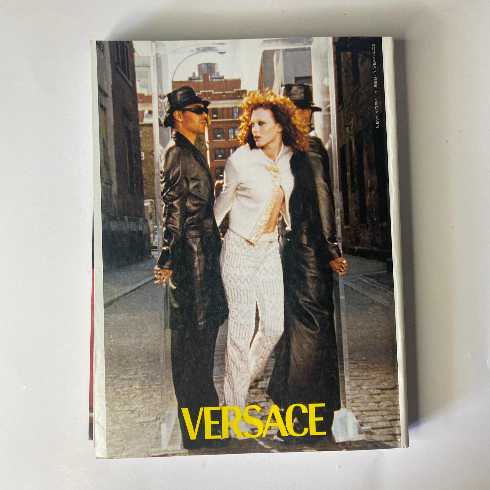 A visually captivating advertisement from Vogue Magazine November 1999, featuring Versace, showcasing cutting-edge fashion, alongside the famous Kate Moss and Gisele Bündchen cover.