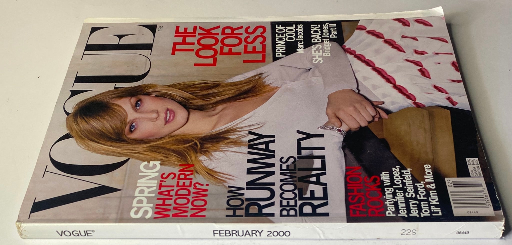 Side view of Vogue Magazine February 2000 with Angela Lindvall on the cover, showcasing headlines about fashion trends and modernity. The magazine is in very good condition and highlights notable cultural insights for collectors.