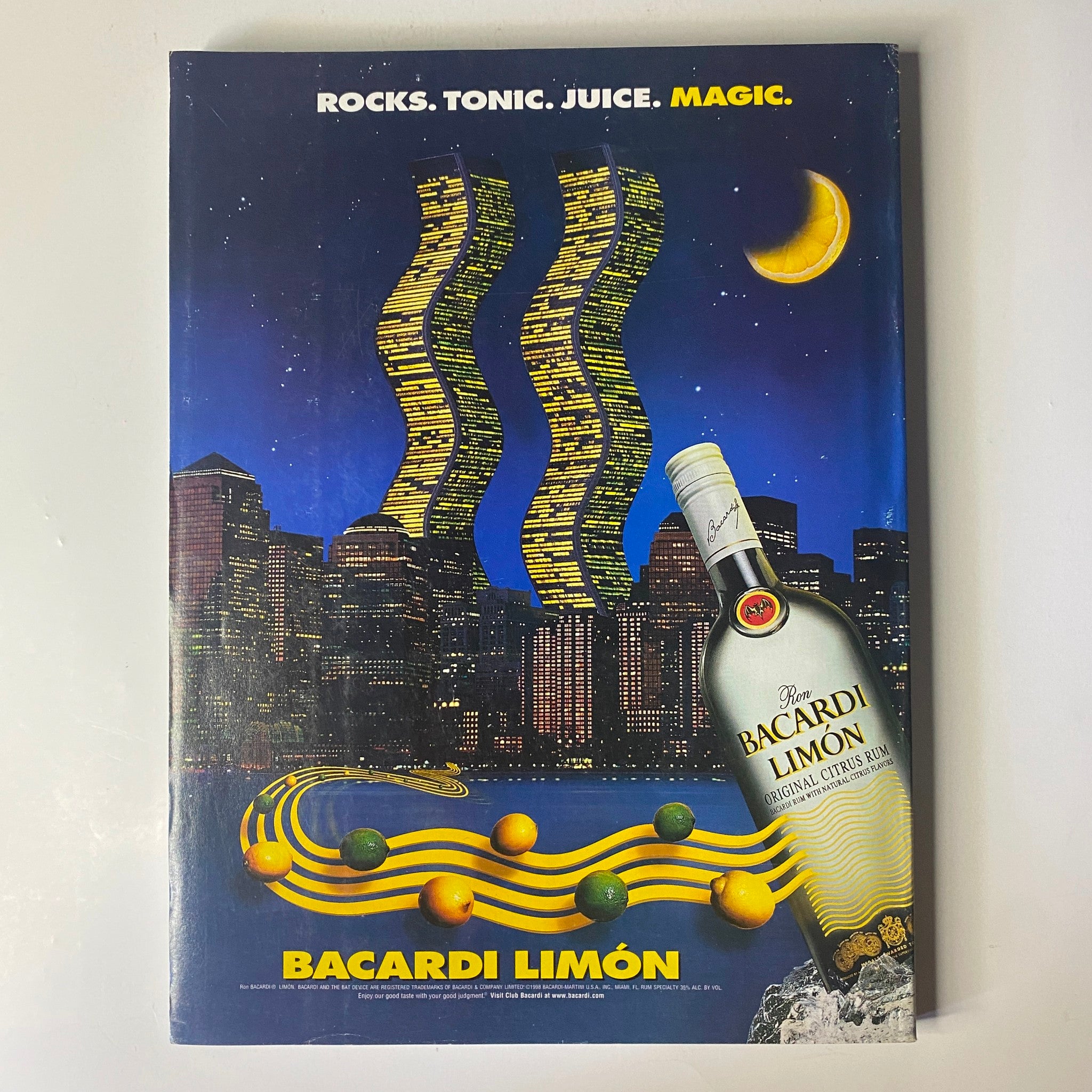 Vogue Magazine May 2000 Gisele Bündchen Cover featuring a Bacardi Limón advertisement set against a dramatic night skyline, showcasing the brand's refreshing beverage products.