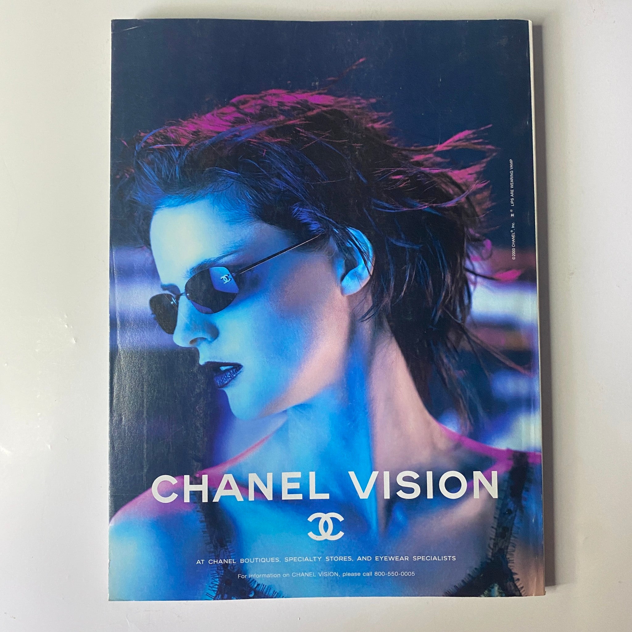 Cover ad for Chanel Vision featured in Vogue Magazine June 2000, displaying a model in stylish eyewear with dramatic blue lighting, highlighting the brand's iconic aesthetic.