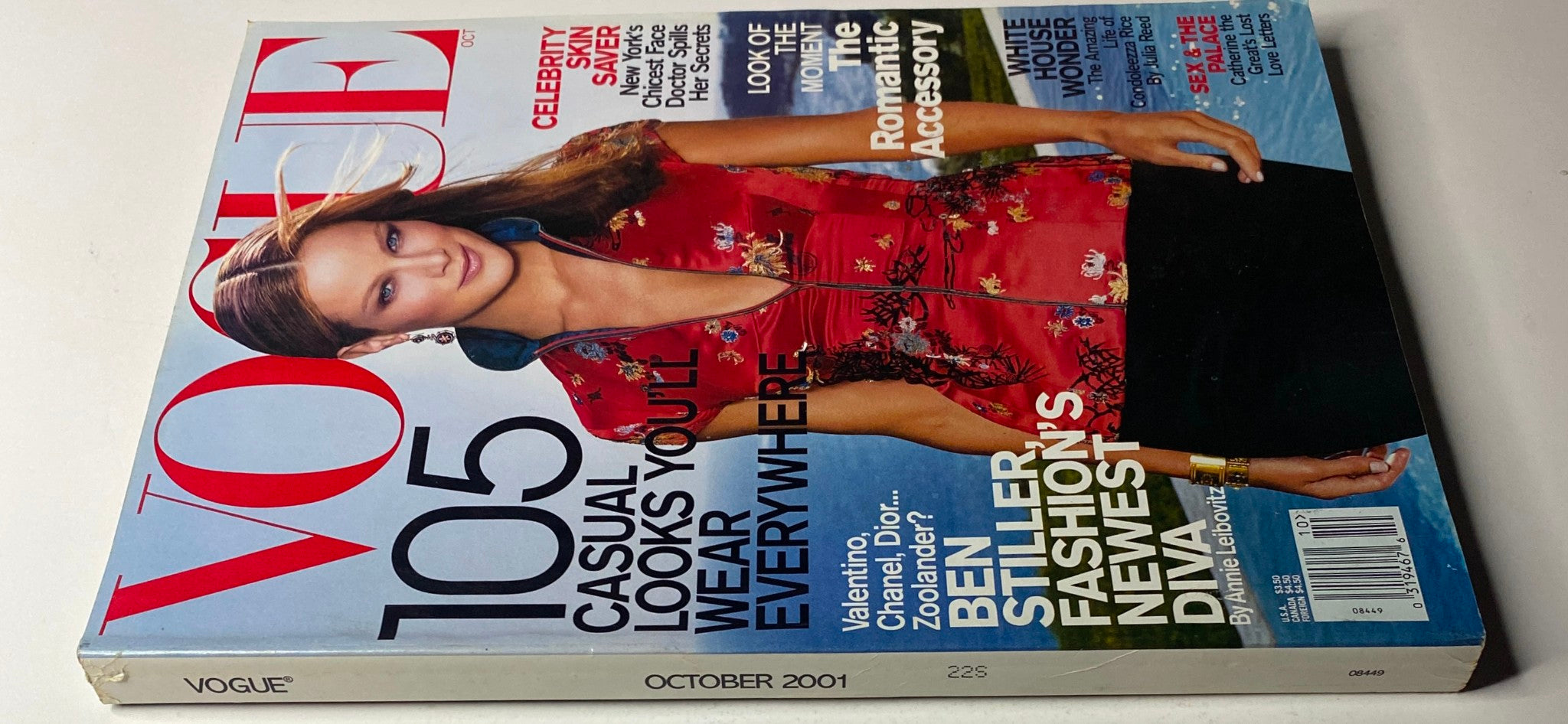 Another angle of Vogue Magazine October 2001 with Carolyn Murphy on the cover, showcasing a vibrant floral top and text discussing celebrity skin care and fashion trends of the time.
