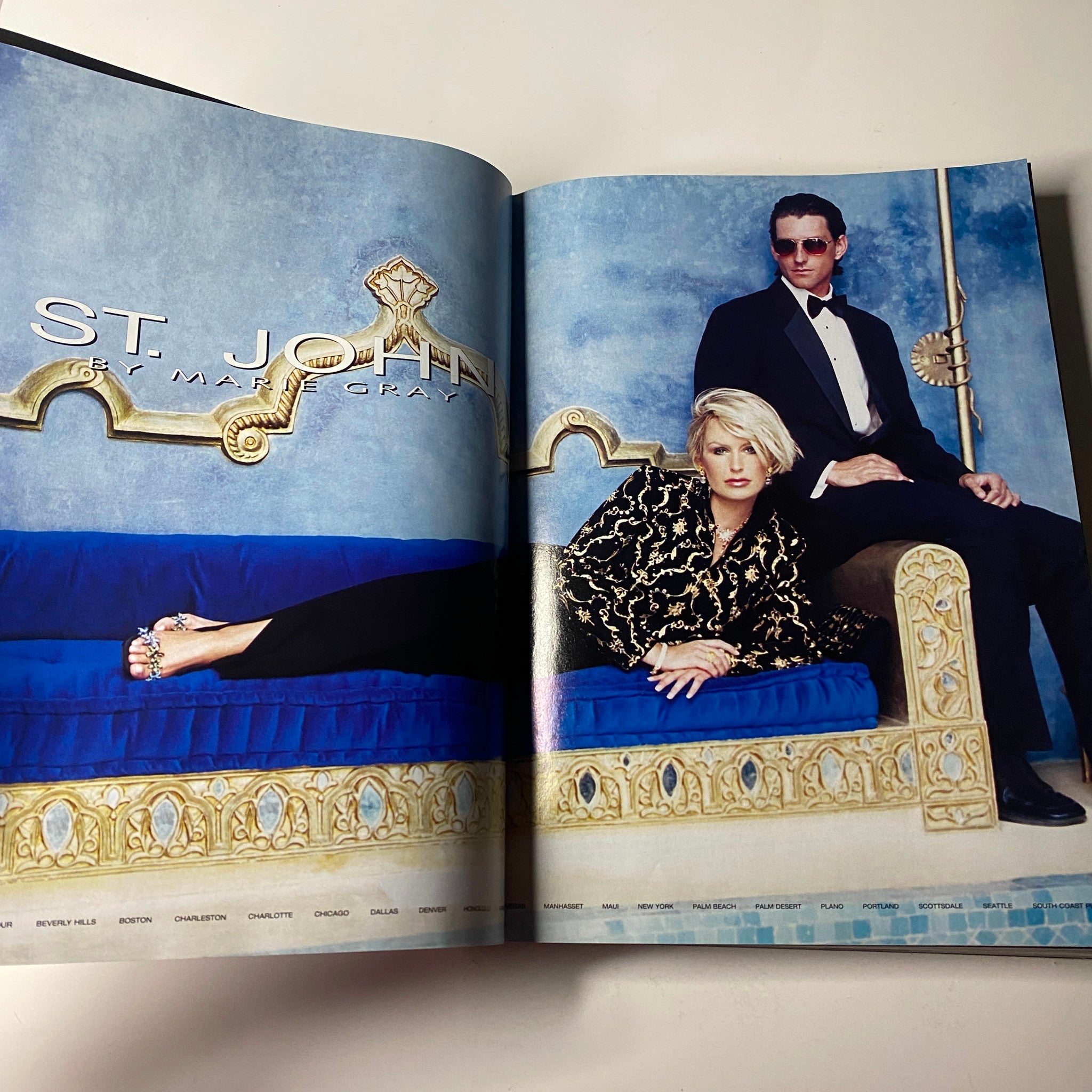 Vogue Magazine November 2001 featuring a fashion spread for St. John by Marie Gray, showcasing a male model in formal wear and a female model elegantly posed on a luxurious blue couch.