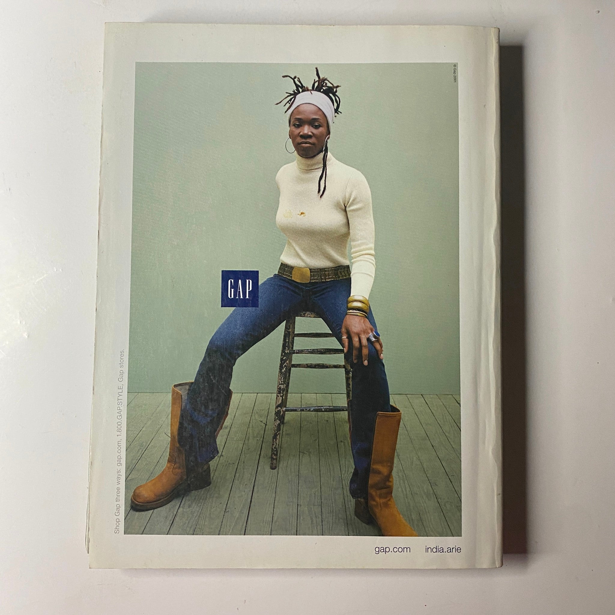 Vogue Magazine November 2001 showcasing a GAP advertisement, featuring a woman with artistic hairstyle wearing a white sweater and denim, posed casually on a stool.