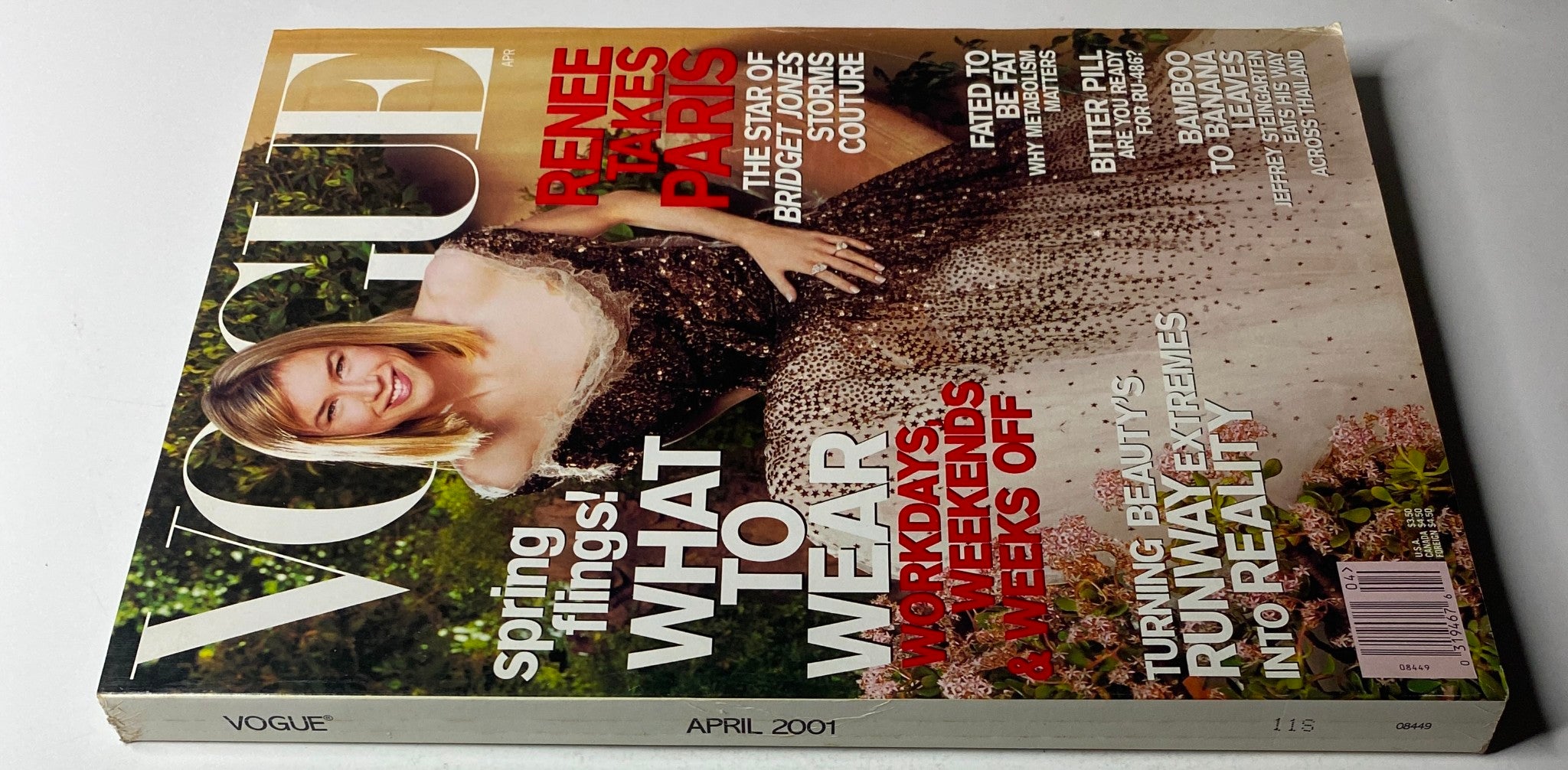 Vogue Magazine April 2001 cover featuring Renée Zellweger in a glamorous gown, highlighting the feature 'Renee Takes Paris'. This issue showcases early 2000s fashion and iconic celebrity styling.