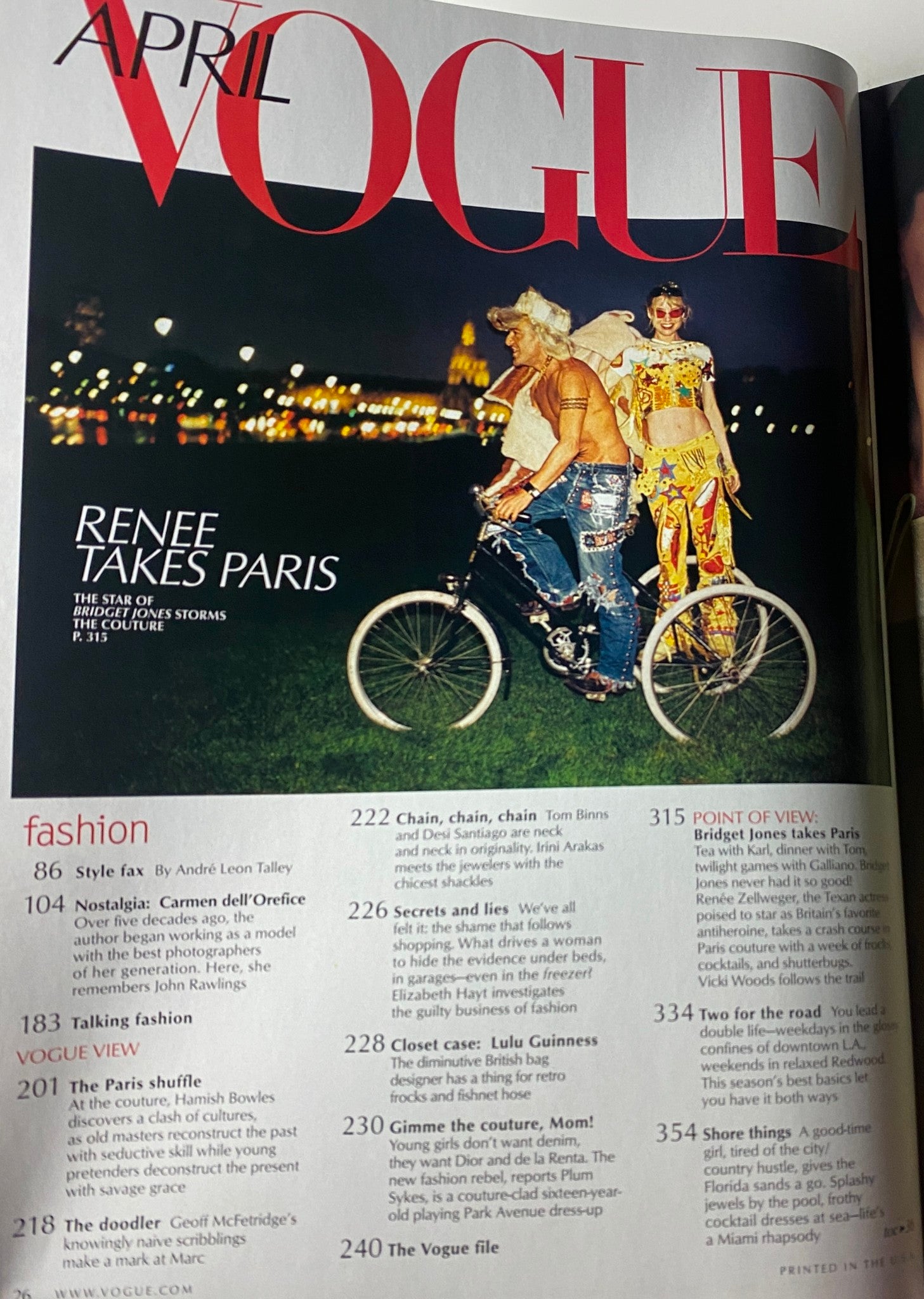 Inside page from Vogue Magazine April 2001 showing the 'Renee Takes Paris' feature, with a vibrant photograph of Renée Zellweger on a bicycle, captured in a stylish outdoor setting.