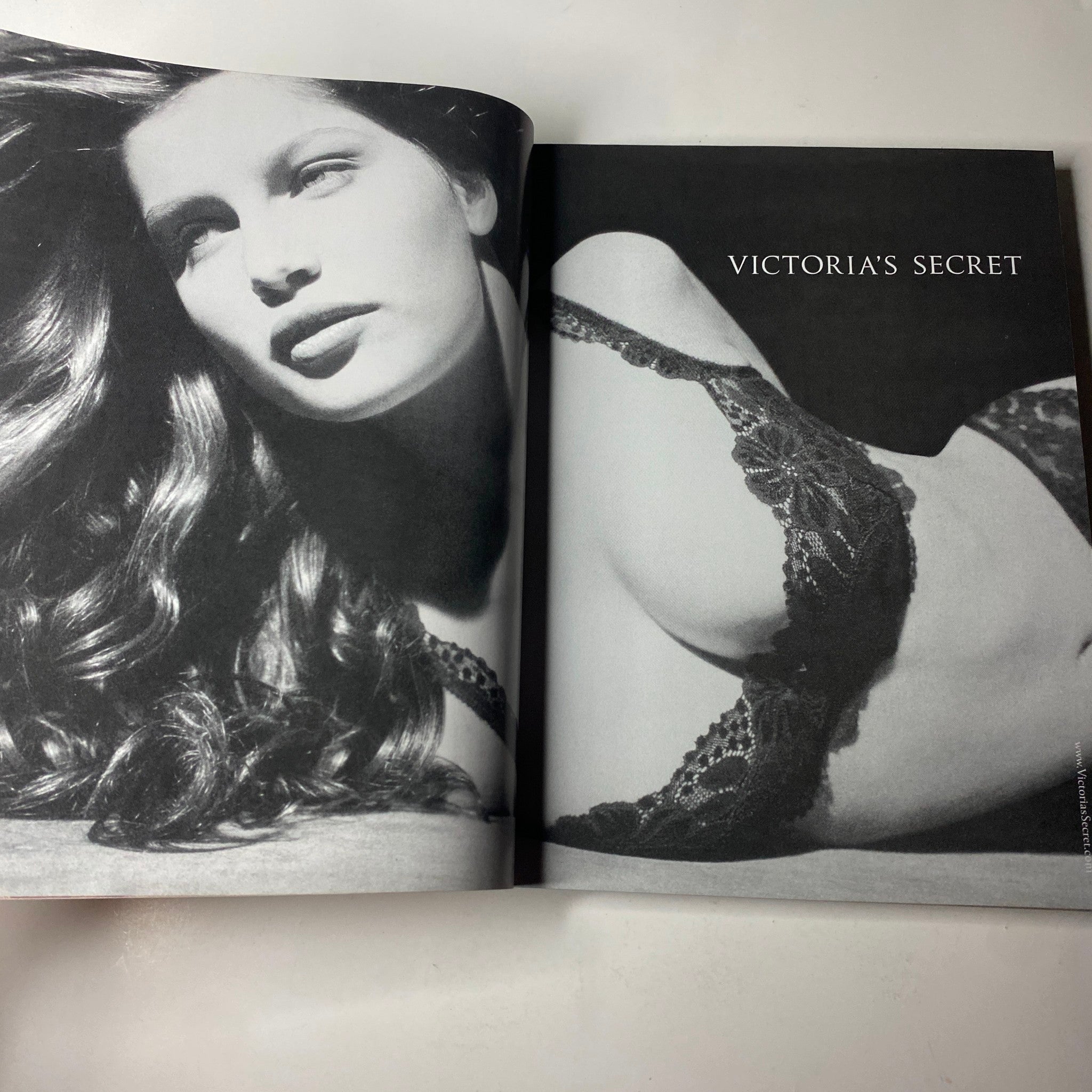 Fashion advertisement page in Vogue Magazine April 2001 highlighting a black and white photo of a model for Victoria's Secret, emphasizing the sensual aesthetics of early 2000s lingerie.