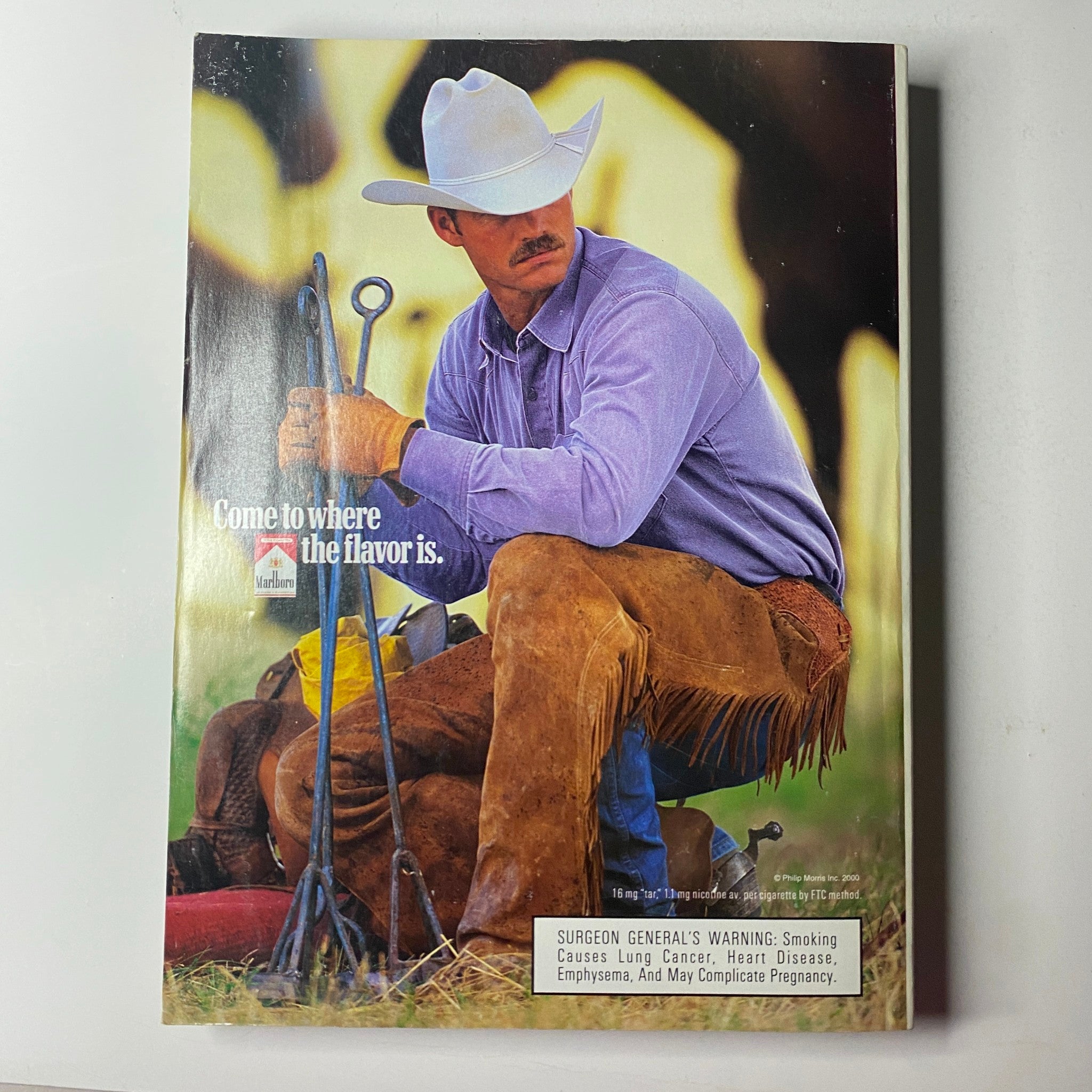 Vogue Magazine March 2000 Amber Valletta Cover, showcasing an advertisement for Marlboro with a cowboy in rustic attire, highlighting classic Americana.