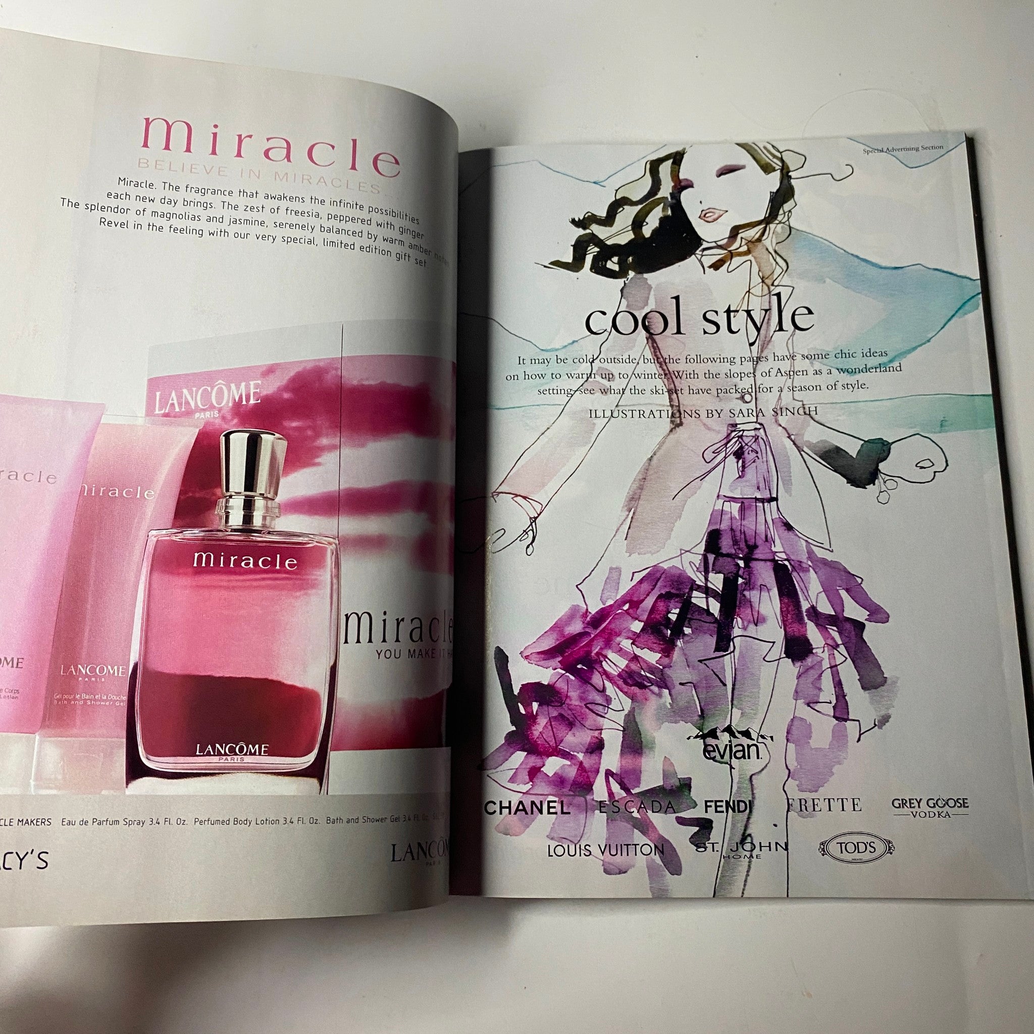 Vogue Magazine February 2002 Sarah Jessica Parker Cover No Label displays an advertisement for Lancôme's 'Miracle' fragrance alongside a stylish illustration of fashion trends, highlighting cool style concepts.
