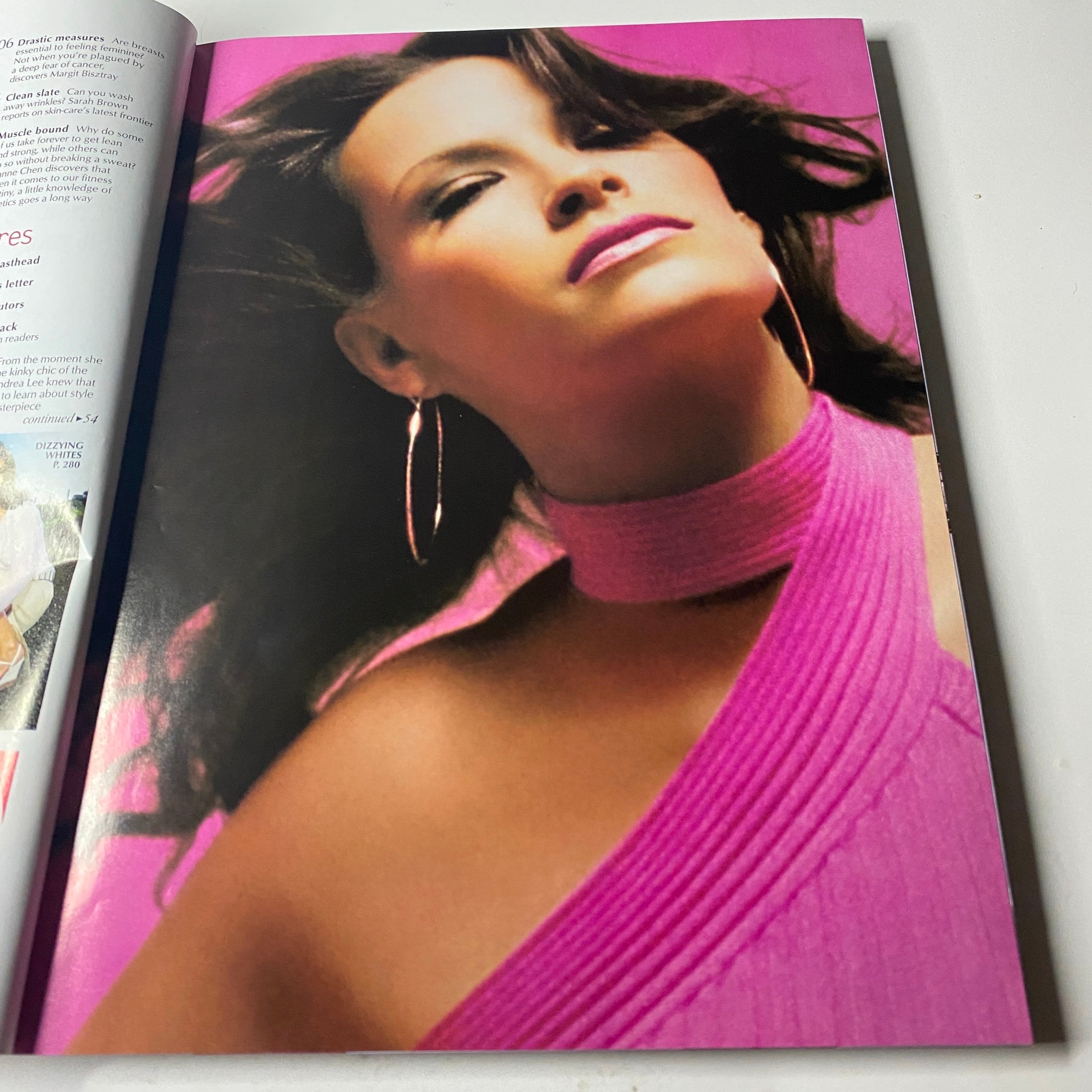Full-color fashion spread in Vogue Magazine May 2002 featuring a model in a pink outfit, emphasizing beauty and modern style.