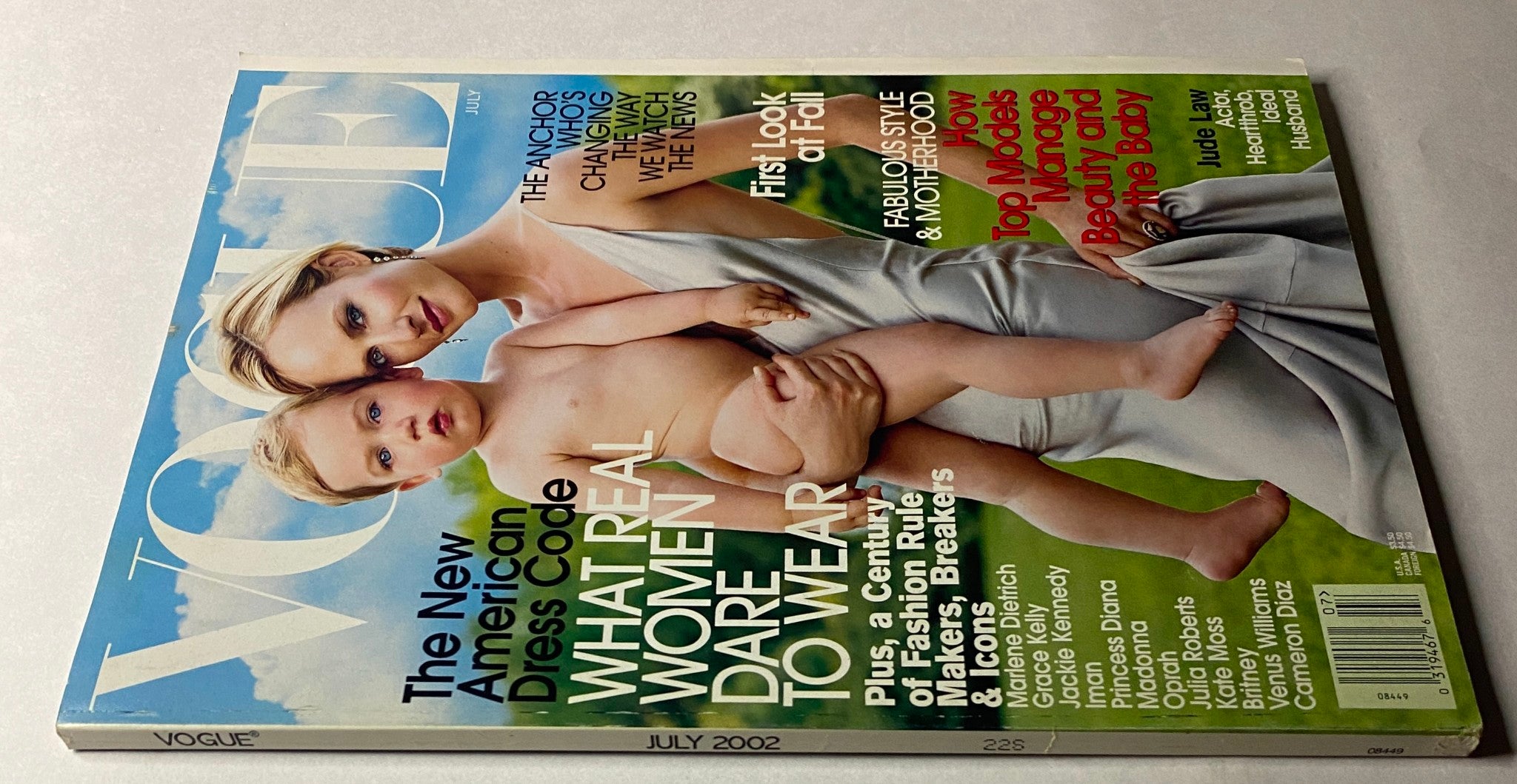 Back view of Vogue Magazine July 2002 with Amber Valletta on the cover, highlighting feature articles on fashion, motherhood, and the New American Dress Code.