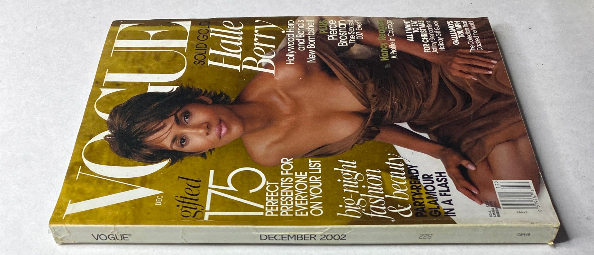 Vogue Magazine December 2002 with Halle Berry on the cover, highlighting holiday fashion and beauty tips, emphasizing the issue's collectible nature.