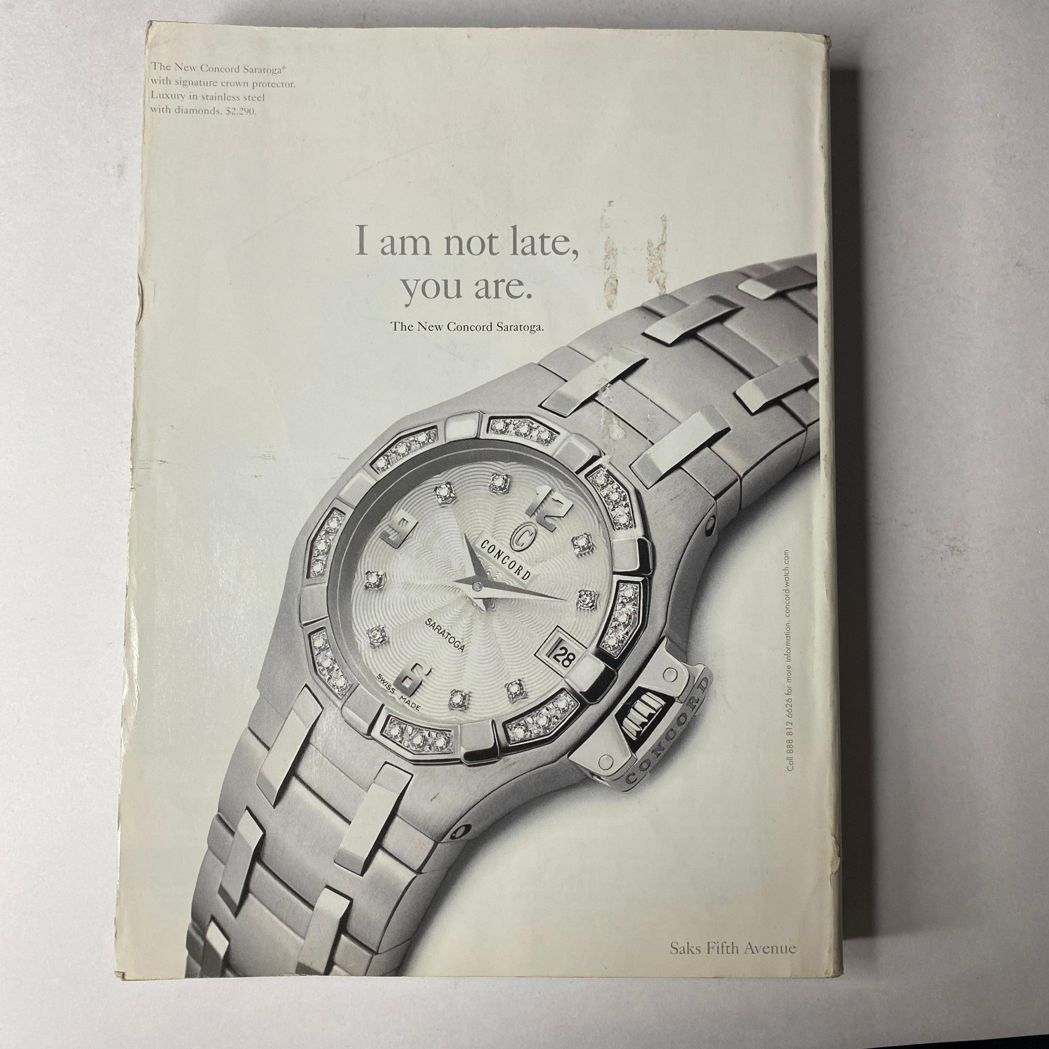 Vogue Magazine September 2002 with a sleek advertisement for Saks Fifth Avenue showcasing a luxury watch, emphasizing elegance and sophistication.