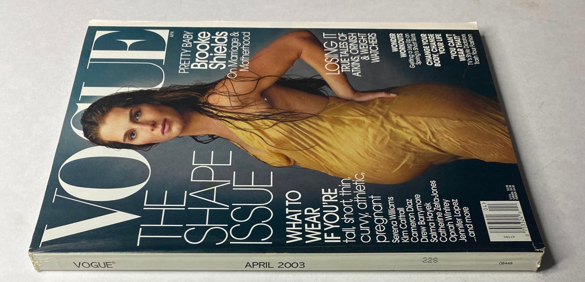 Close-up of the April 2003 Vogue Magazine cover with Brooke Shields, showcasing her in a vibrant yellow dress, emphasizing the magazine's focus on pregnancy and style.