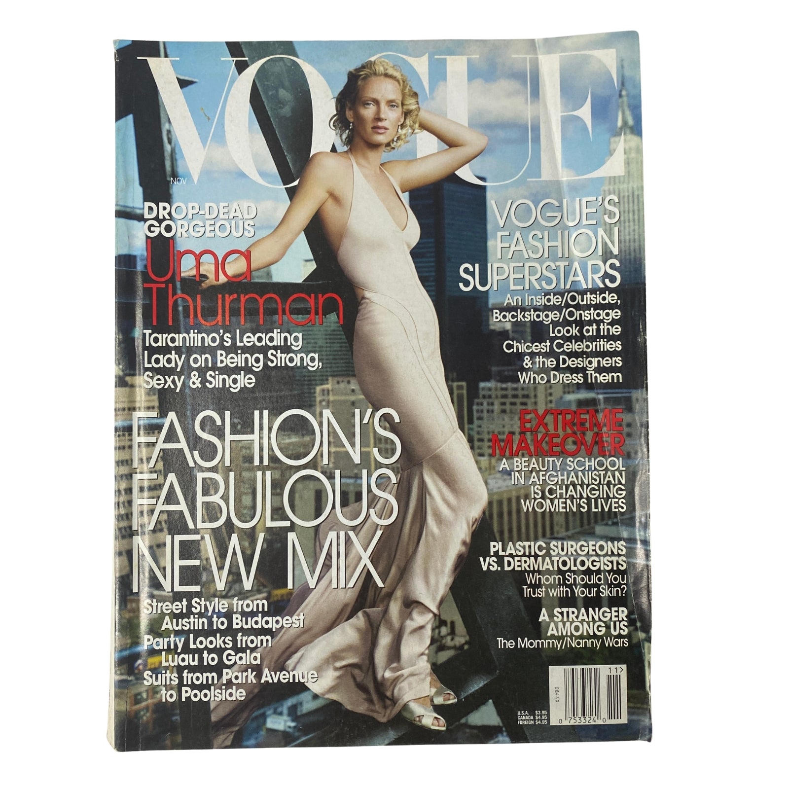 Vogue Magazine November 2003 cover featuring Uma Thurman in a stunning gown, showcasing fashion highlights of the issue.