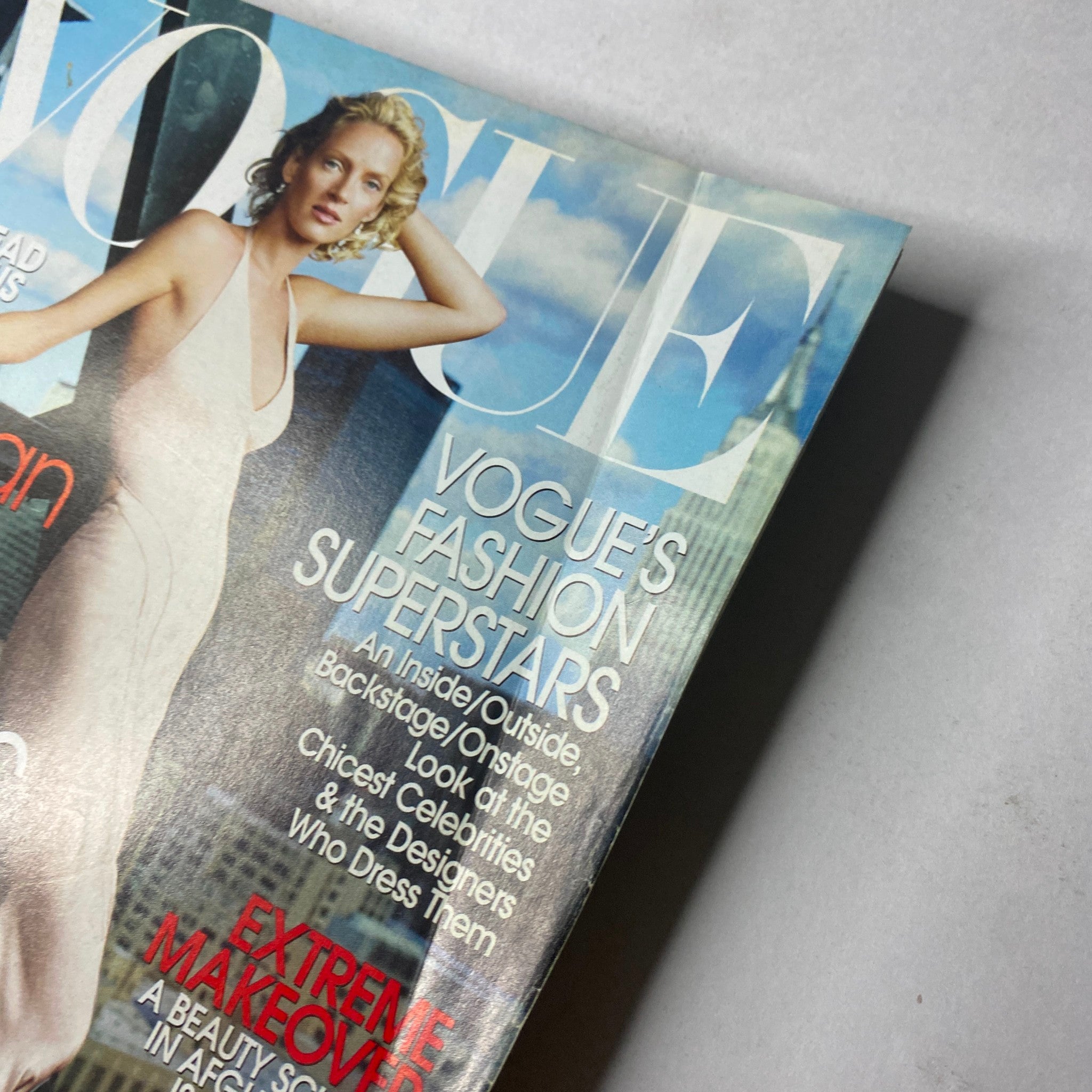 Close-up of Vogue Magazine November 2003 cover with Uma Thurman, emphasizing the magazine's focus on fashion superstars.