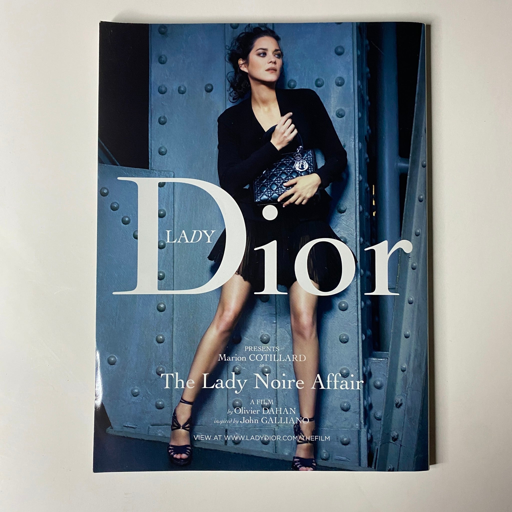 Cover of the Lady Dior film pamphlet featuring actress Marion Cotillard, promoting 'The Lady Noire Affair' and complementing the fashion themes in Vogue Magazine August 2009.