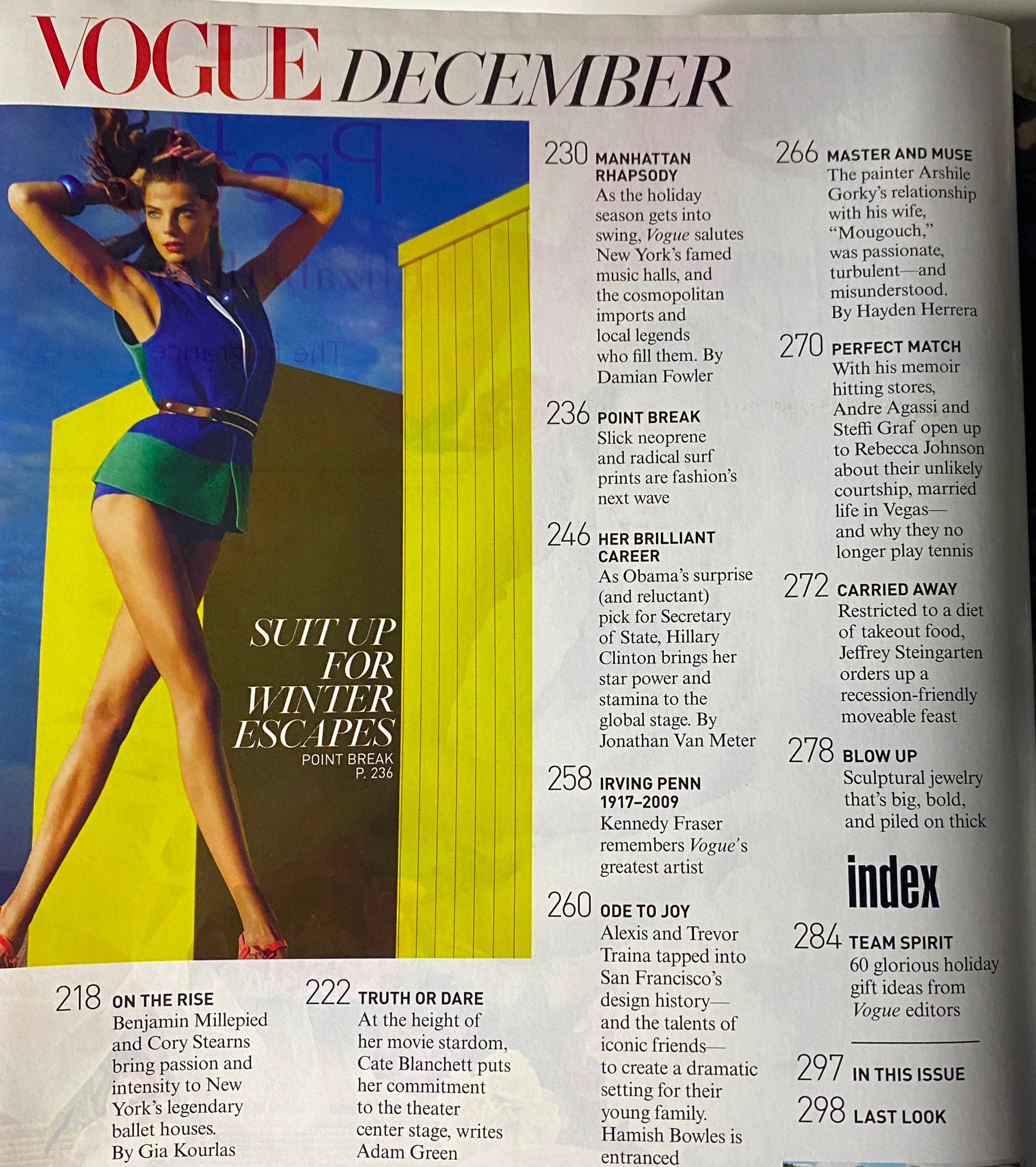 Vogue Magazine December 2009 features a fashion editorial titled 'Suit Up for Winter Escapes'. The image showcases a model in colorful attire against a bright backdrop, highlighting winter fashion trends.