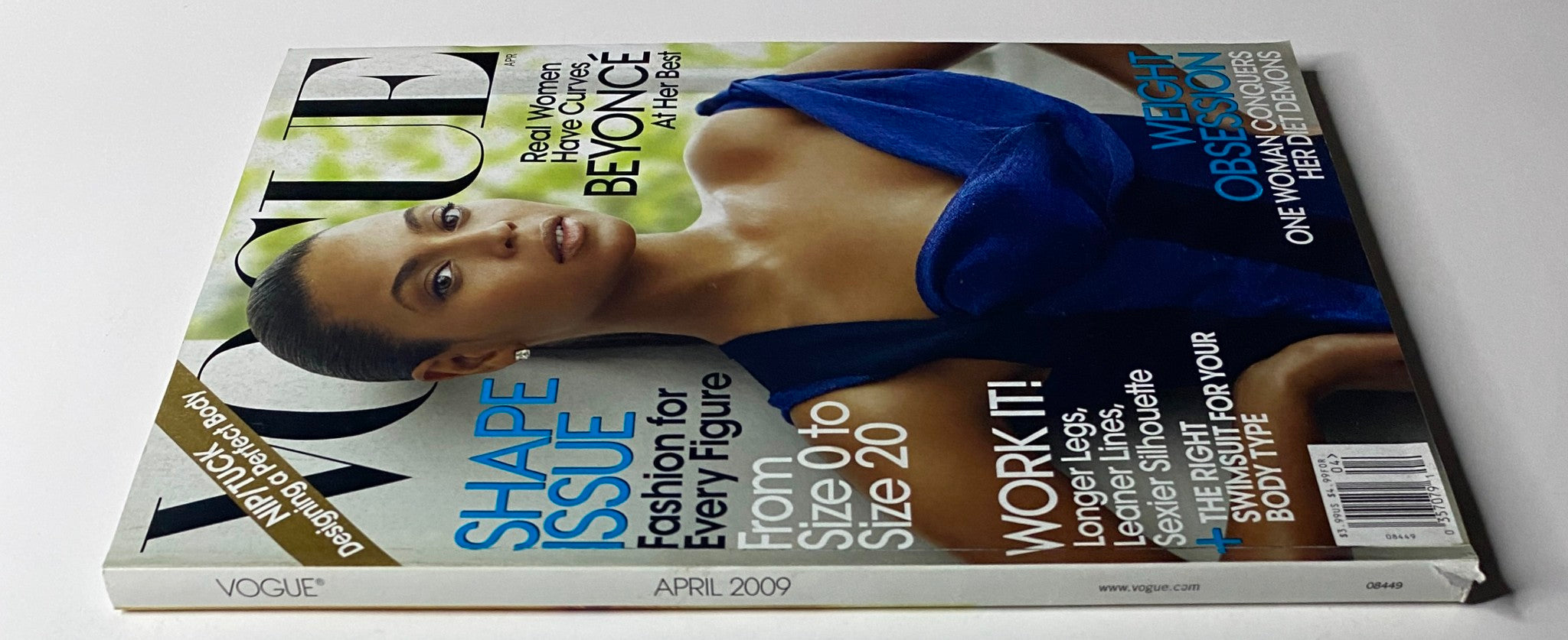 Vogue Magazine April 2009 edition showcasing a side view of the cover featuring Beyoncé in a blue dress. The text promotes 'Shape Issue' and focuses on fashion for various sizes from 0 to 20.