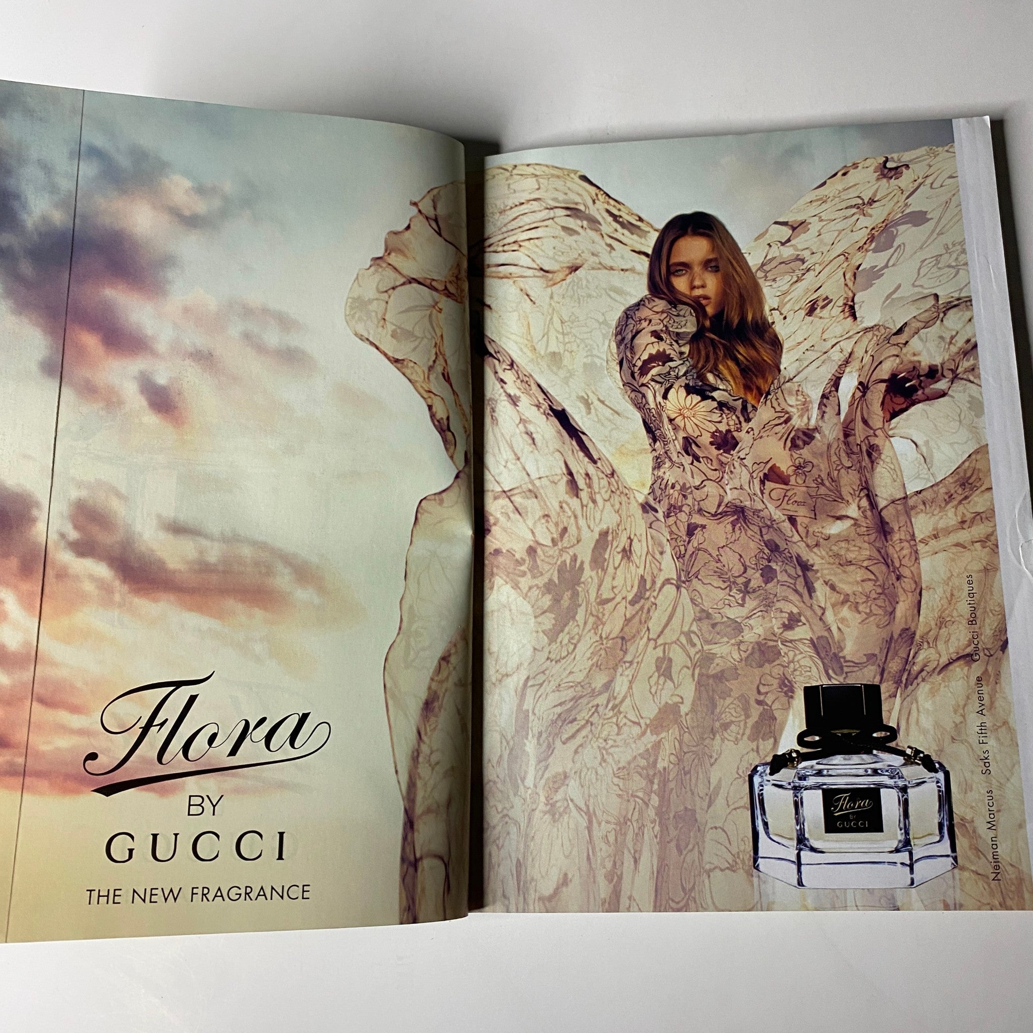 Vogue Magazine May 2009 advertisement for Flora by Gucci, featuring a model in a flowing dress promoting the fragrance, enhancing the magazine's luxurious and fashionable appeal.
