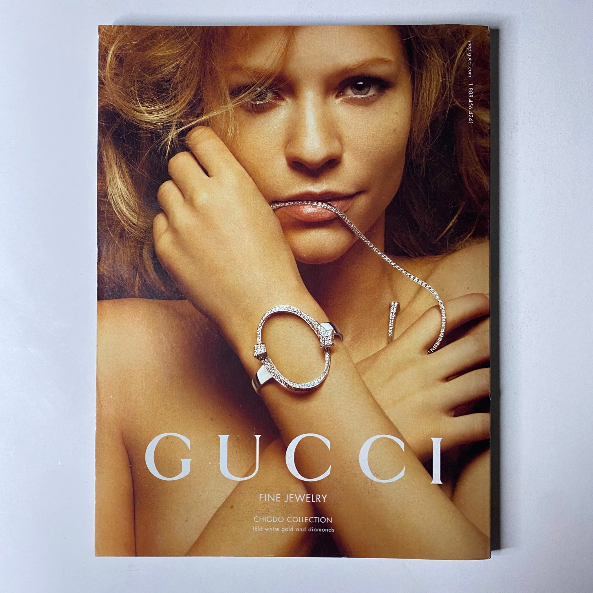 Cover of the Gucci Fine Jewelry catalog featuring a model showcasing elegant jewelry pieces. This image promotes high-end fashion luxury alongside Vogue Magazine's editorial style.